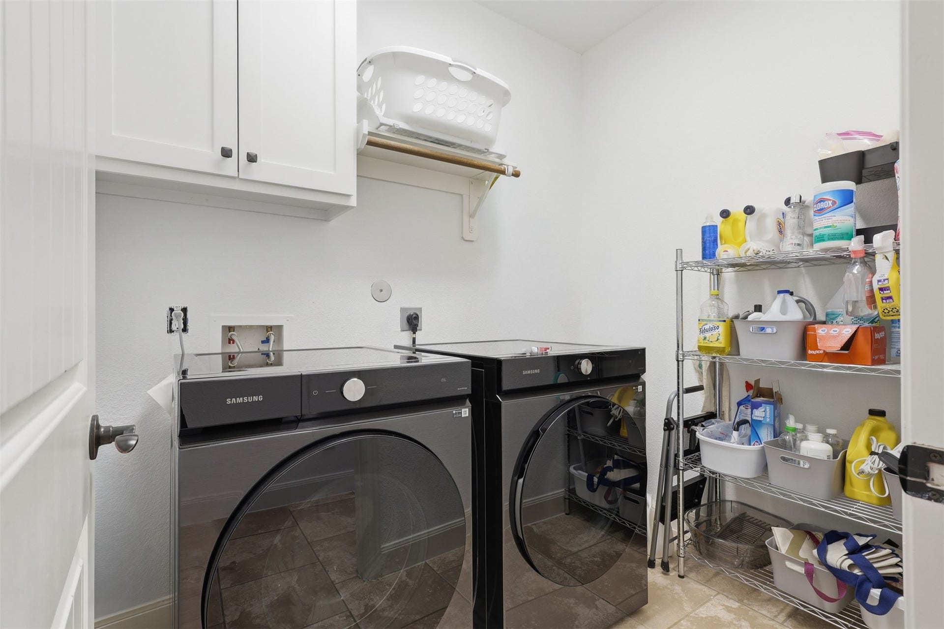 Dedicated utility room with built-in cabinetry and convenient indoor laundry space.