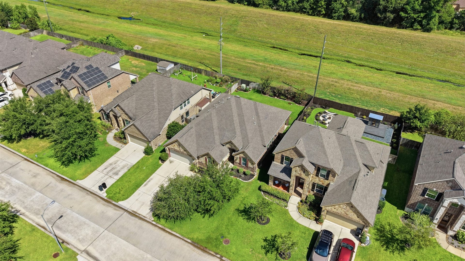 Elevated view highlights the propertys generous lot and green space behind the home.
