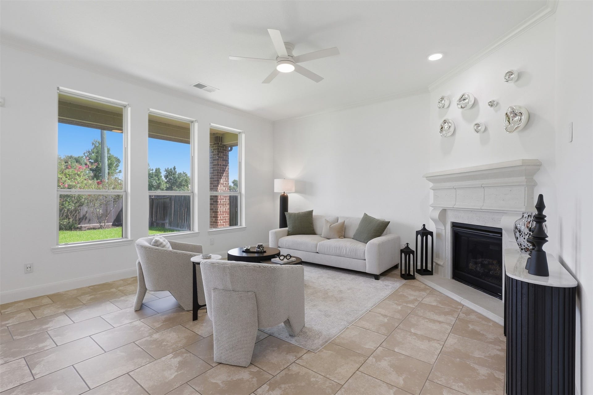 Spacious family room filled with natural light and centered around a cozy gas-log fireplace.
