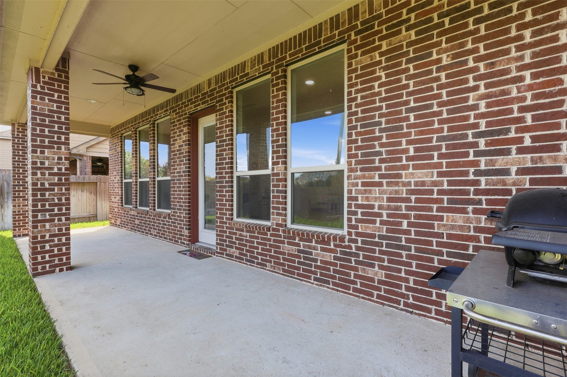 Covered back patio provides a shaded space for outdoor dining and entertaining.