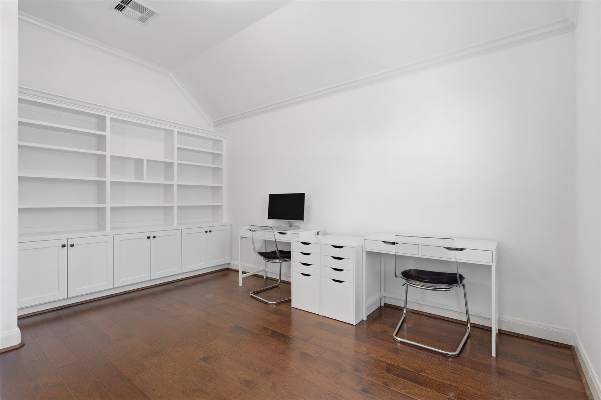 Private home office with custom built-in shelving and workspace.