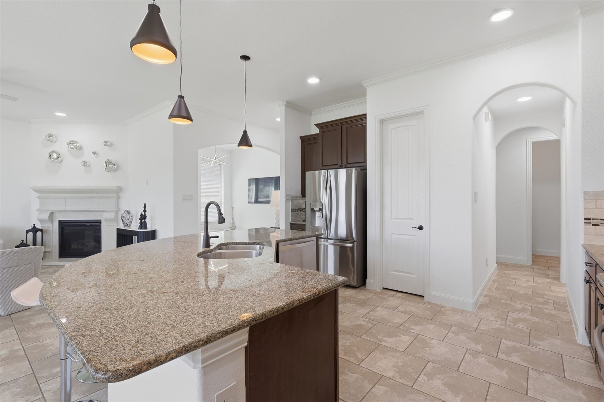 Large kitchen island provides generous prep space and additional seating.