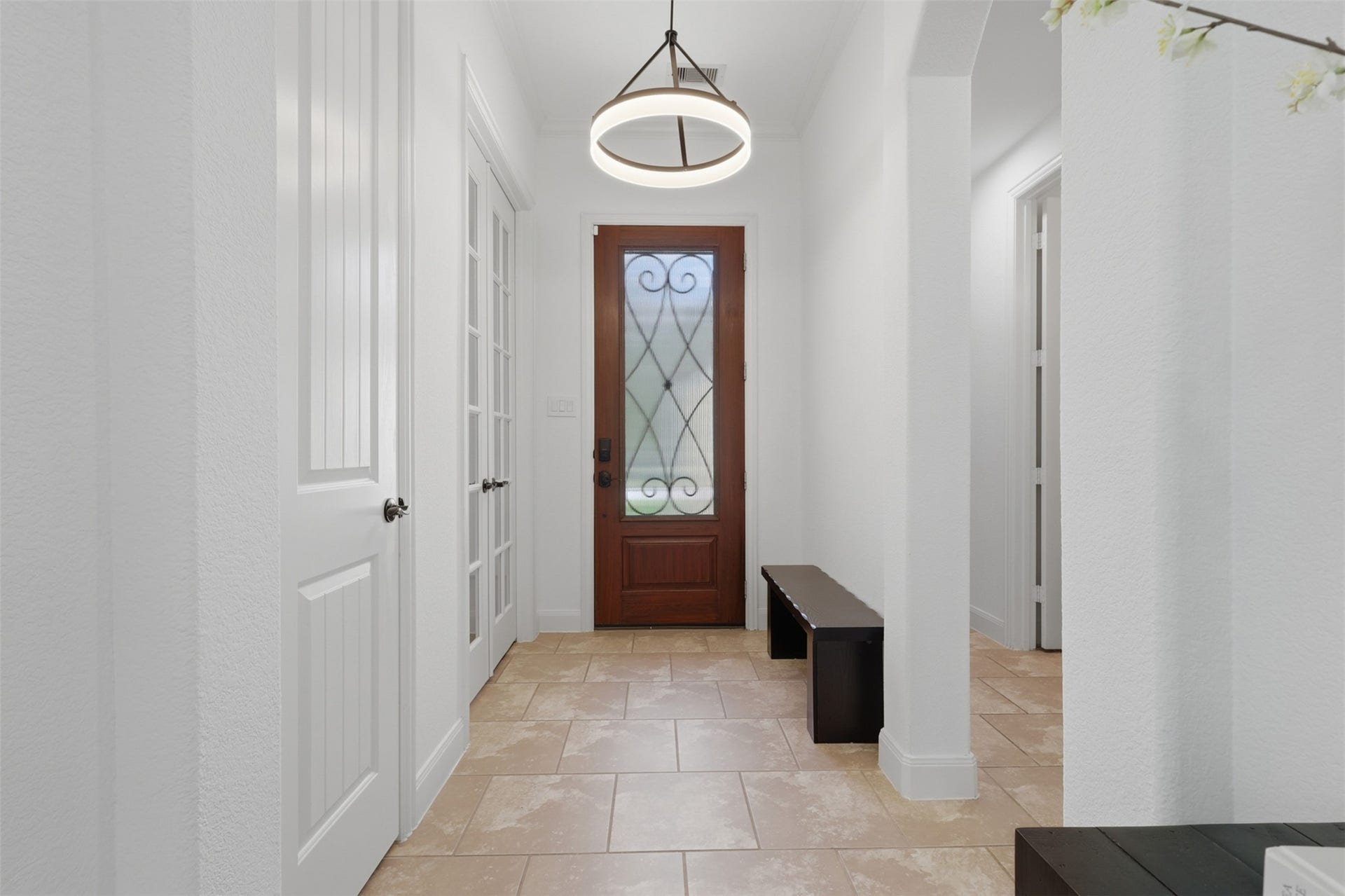 Bright and inviting entryway with neutral finishes throughout.