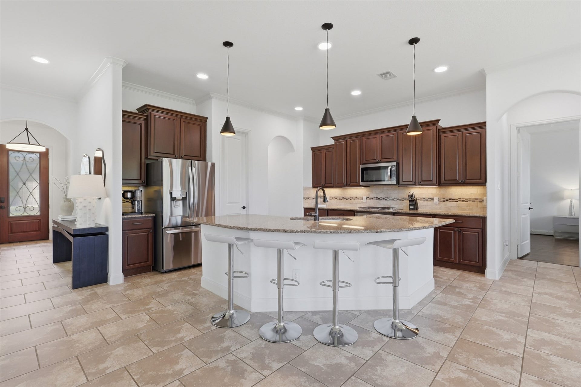 Spacious kitchen features granite countertops, abundant cabinetry, and a large center island.