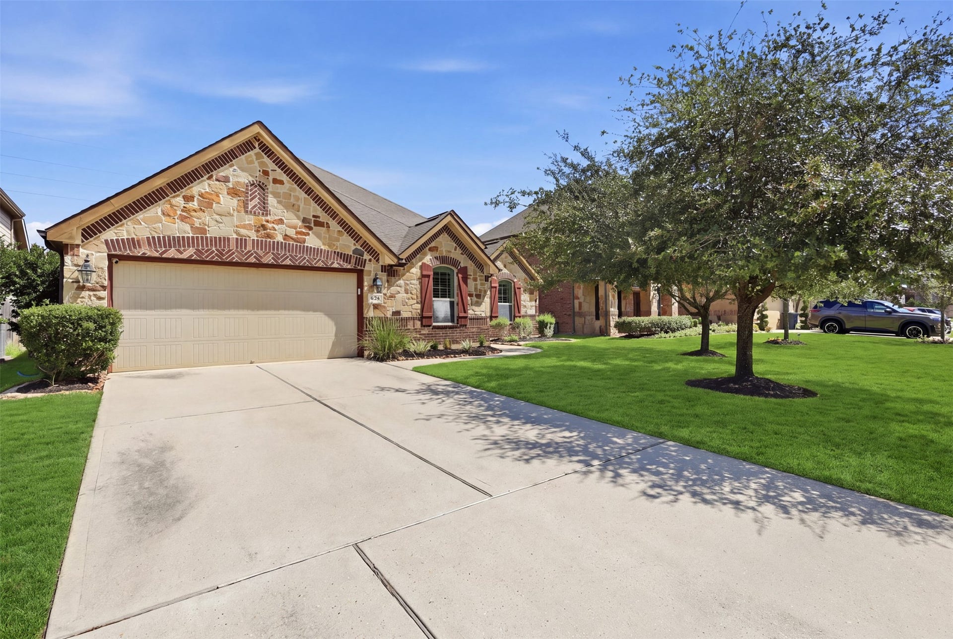 Spacious driveway leads to the attached two-car garage.