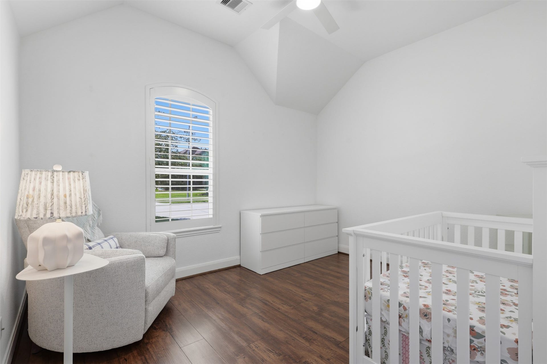 Secondary bedroom with wood vinyl flooring and plenty of natural light.