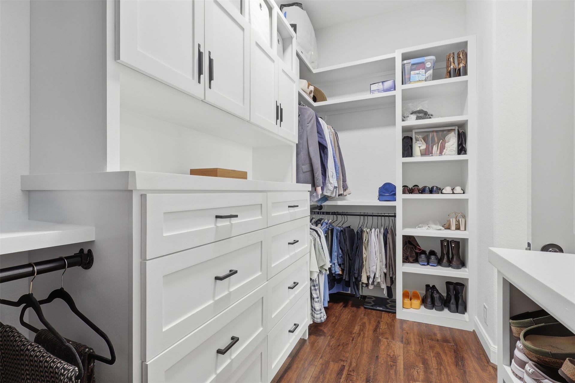 Generous walk-in primary closet offers built-in shelving and storage.