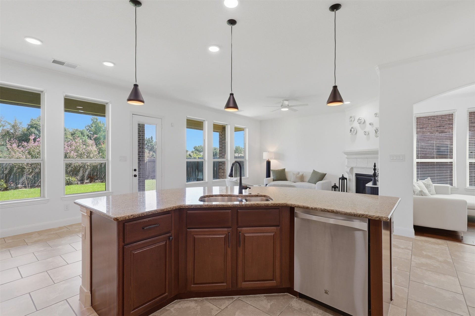 Light-filled breakfast bar surrounded by windows with backyard views.