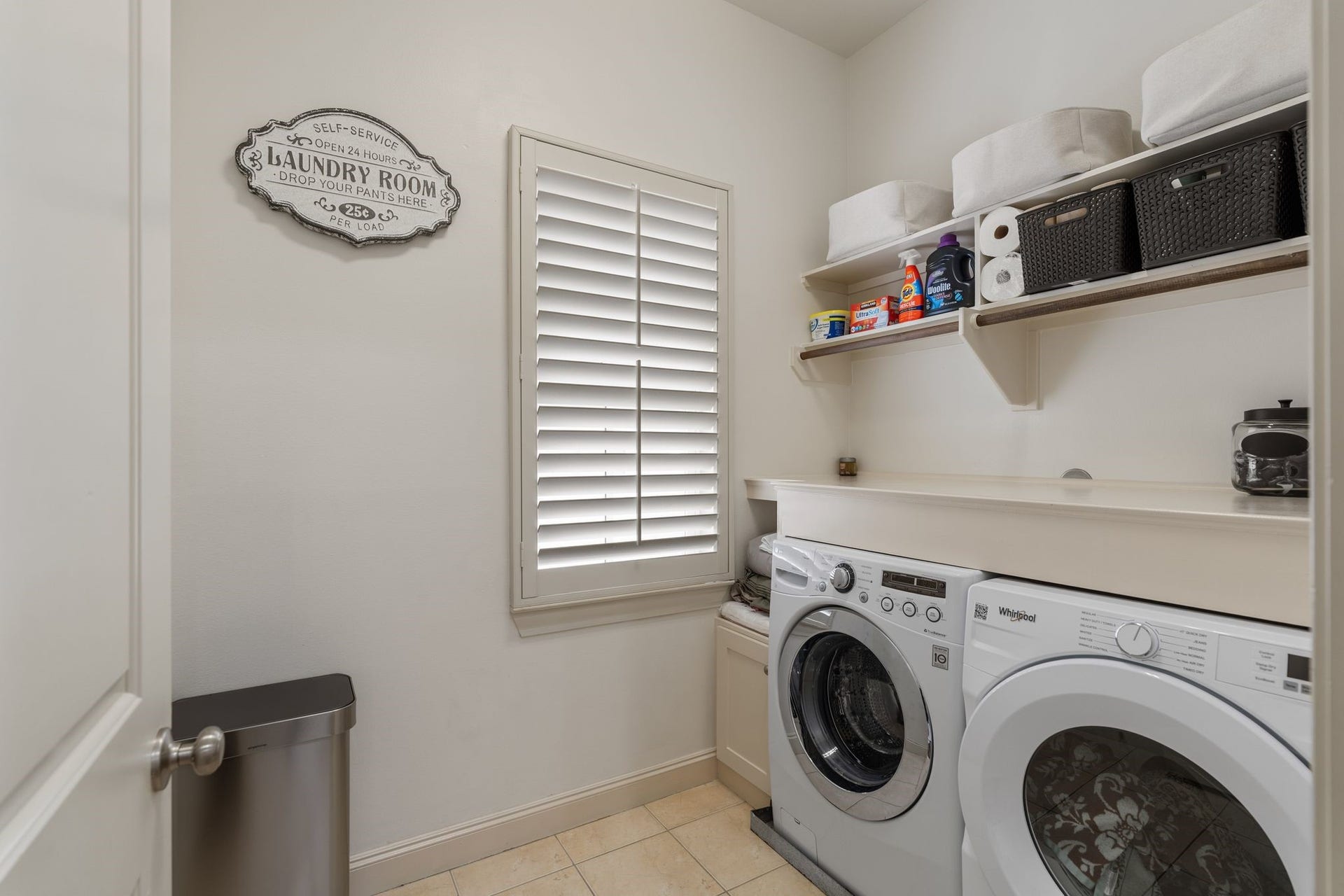 1337 W 24th Street, Houston, TX 77008 The laundry room brings everyday convenience with side-by-side appliances, open shelving and a shuttered window, conveniently located near all the bedrooms.