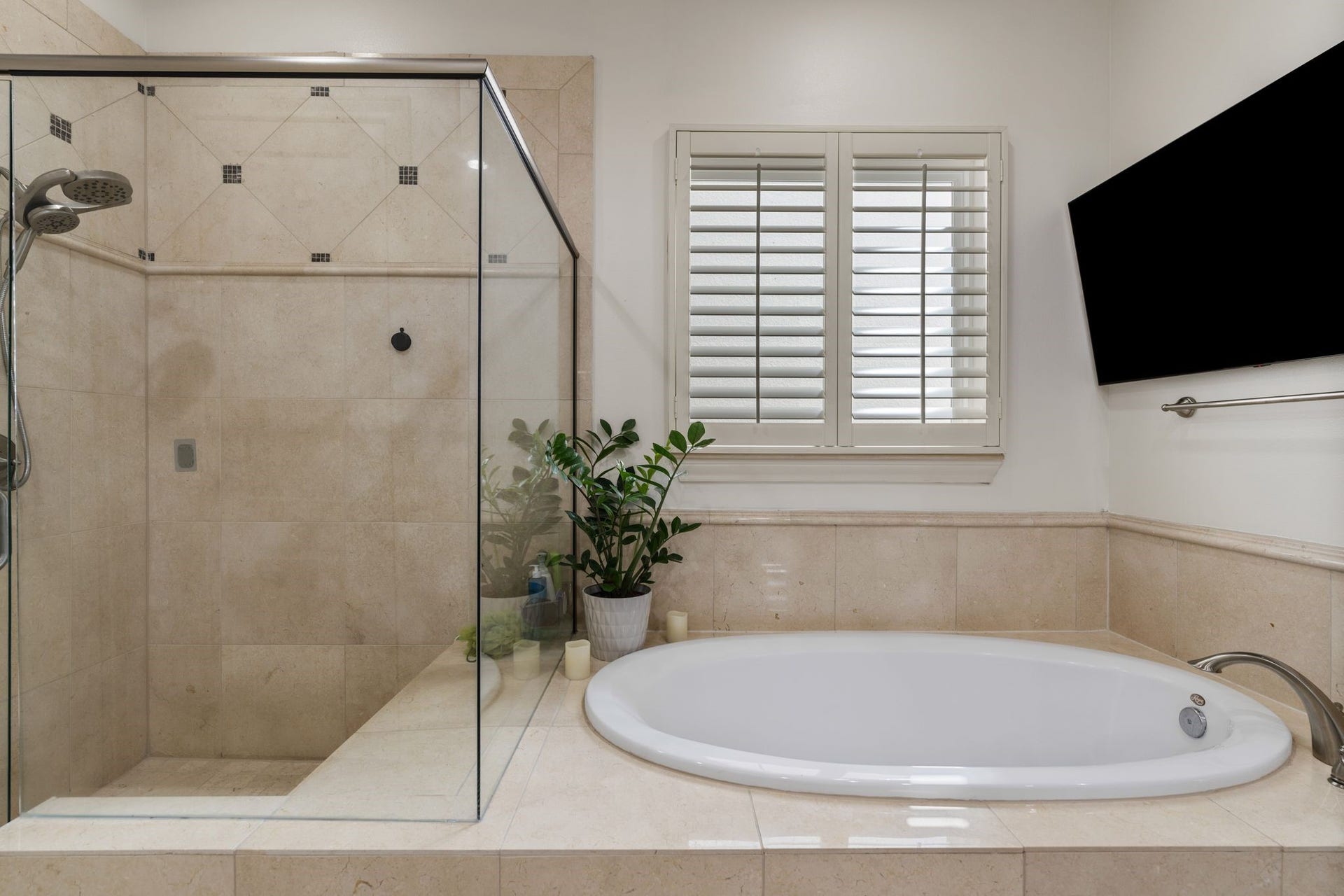 1337 W 24th Street, Houston, TX 77008 A closer look highlights the separate soaking tub, glass-enclosed shower and shuttered window.