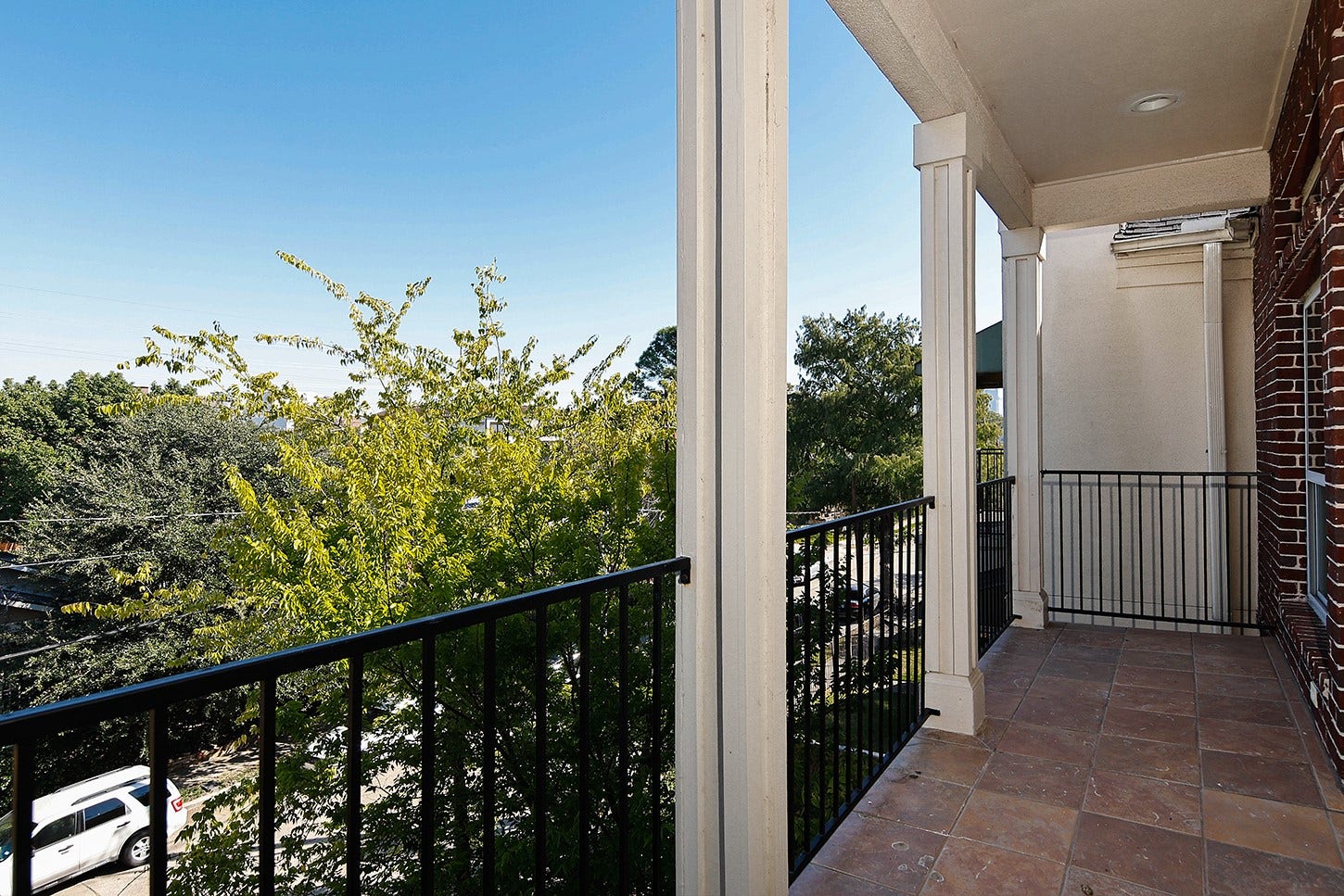 3rd Floor Primary Balcony overlooking the tree lined street and Downtown