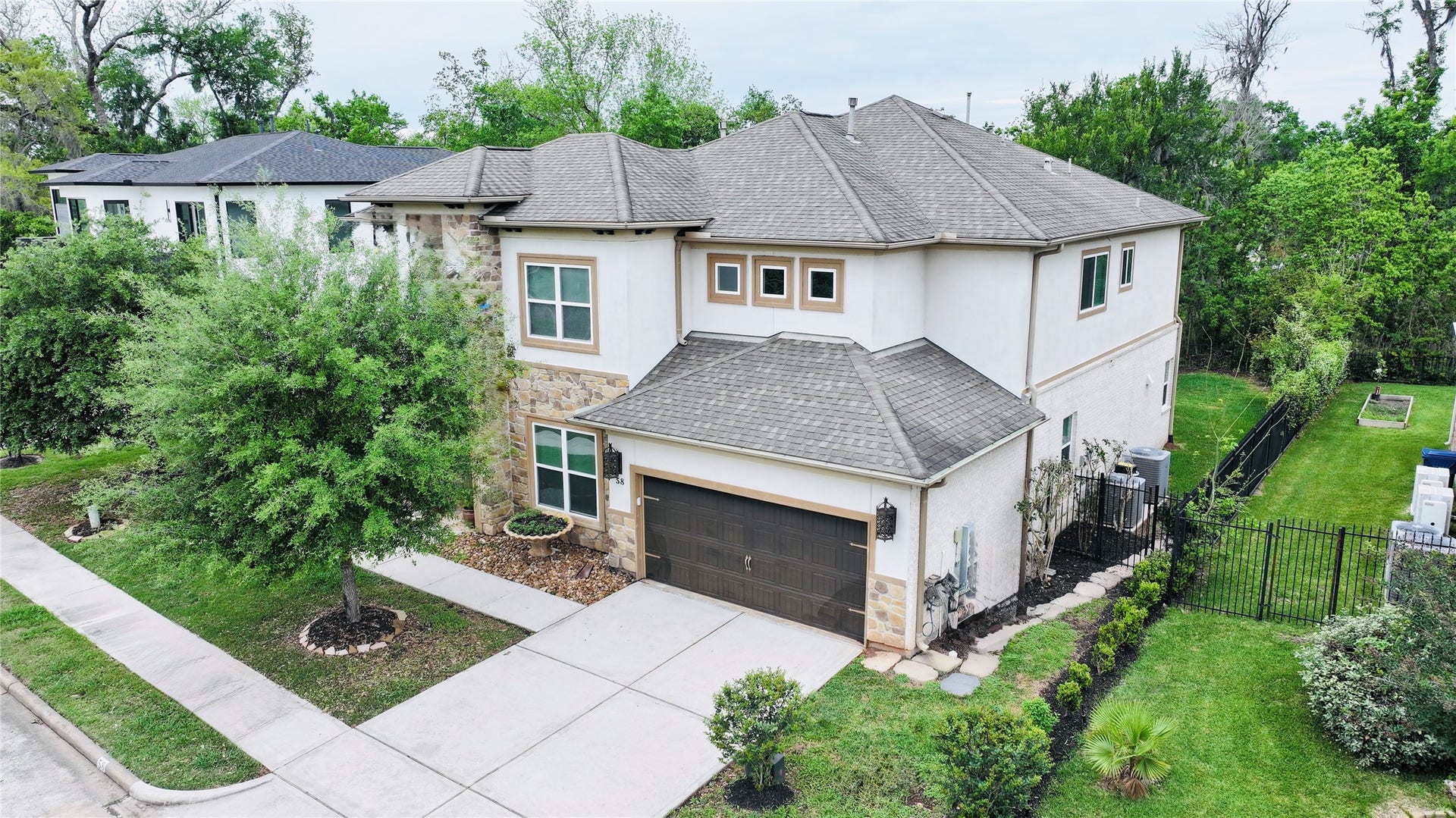 58 Flamingo Landing Drive, Missouri City, TX 77459 A 4,000 SF beauty, no back neighbors, iron gates, sunroom and patio in backyard, million dollar neighbors in a private and gated island.