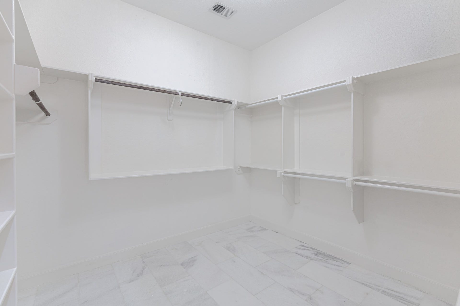 58 Flamingo Landing Drive, Missouri City, TX 77459 A dream walk-in closet as big as a room with marble flooring, built-ins.