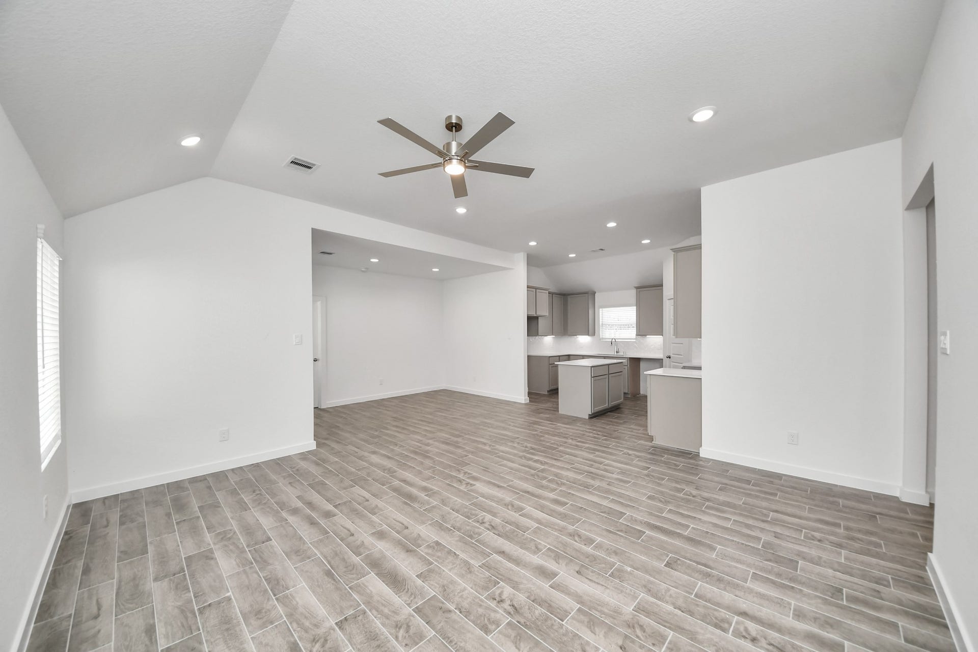 5834 Madison Trail Drive, Richmond, TX 77469 Family room flooded with natural light through the expansive windows. The premium tile flooring adds a touch of luxury to the space, creating the perfect setting for relaxing moments and cherished gatherings with loved ones. Sample photo of completed home with similar floor plan. Actual colors and selections may vary.