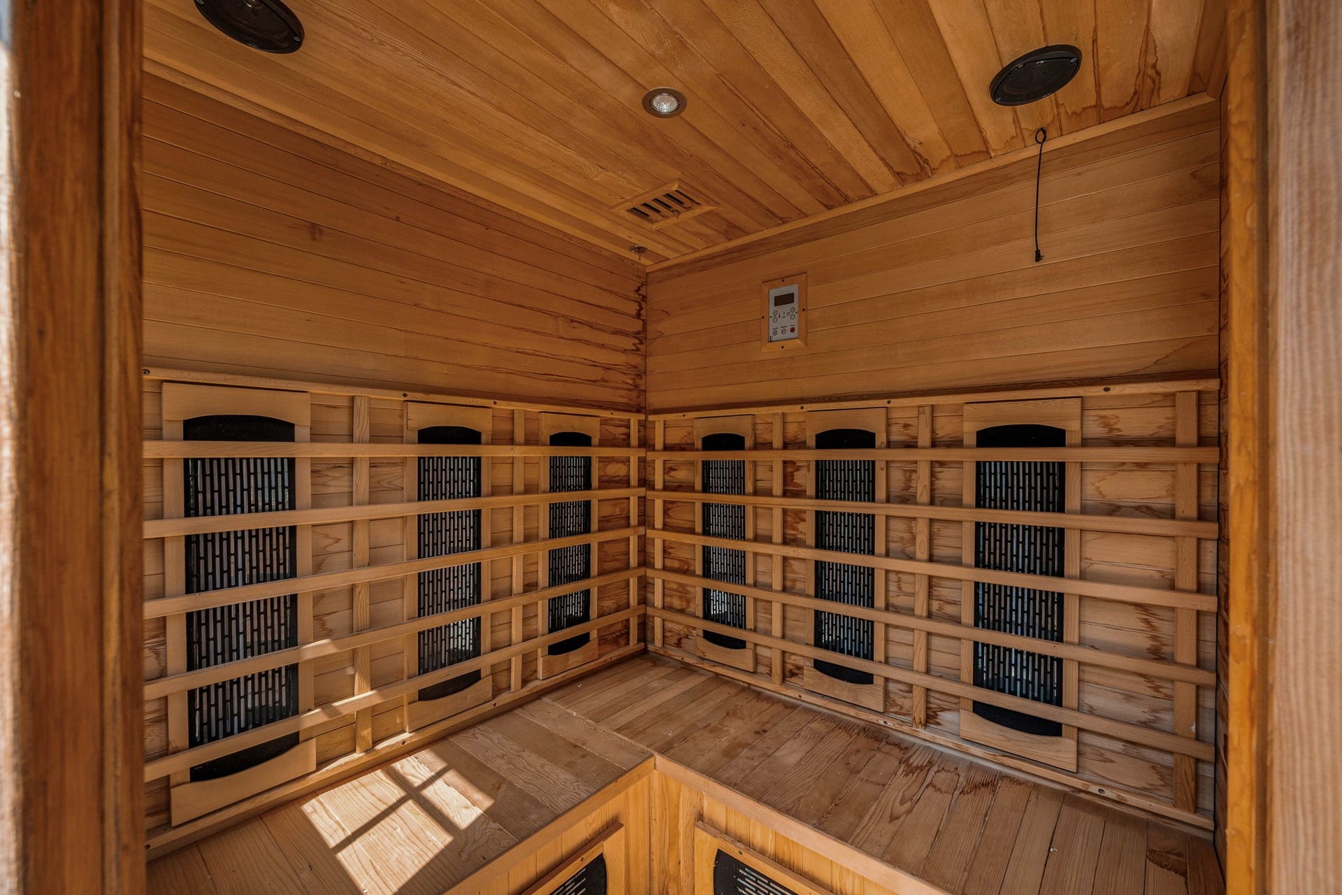 Step inside the private backyard wellness oasis to discover a premium, fully lined cedar infrared sauna that elevates this property to a true luxury retreat. The beautifully crafted interior features multi-level bench seating, integrated wall-mounted heating panels for an efficient and soothing experience, recessed ceiling lighting, built-in audio speakers, and a digital climate control panel to easily customize your relaxation sessions.