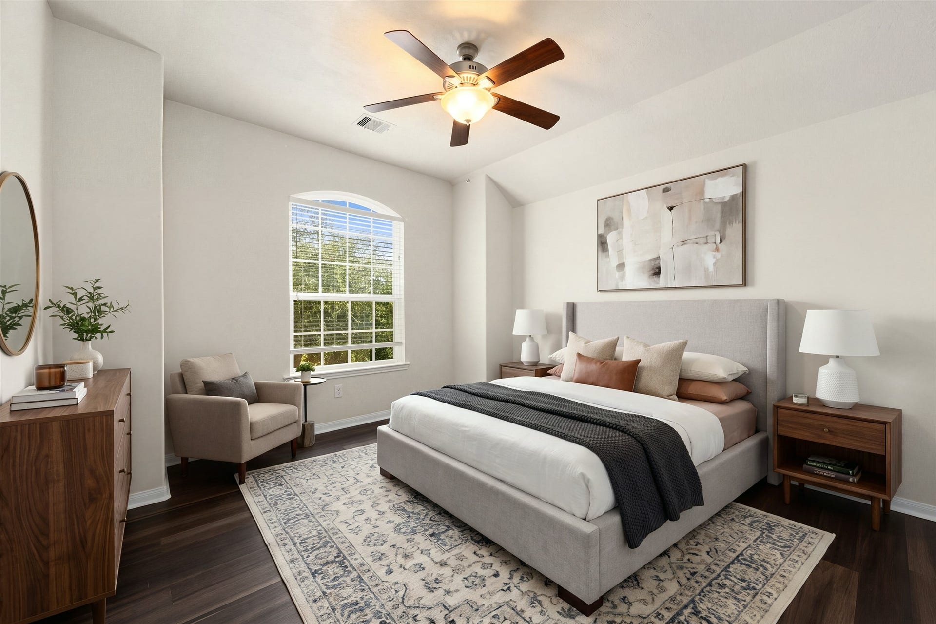 This beautifully appointed third secondary bedroom offers a spacious and flexible layout, ideal for a growing family, a home office, or guest accommodations. Anchored by gorgeous dark wood-look flooring, the room features an elegant arched window that frames peaceful outdoor views, high ceilings, a modern wood-blade ceiling fan, and plenty of closet space. *Virtually Staged