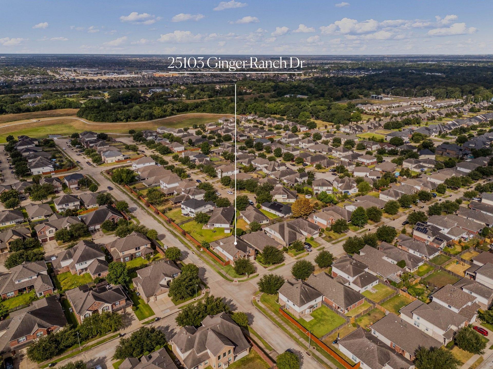 This spectacular aerial perspective highlights the home's premier location within the highly desirable Katy Creek Ranch community. The expansive green spaces and mature trees surrounding the neighborhood, while perfectly pinpointing the property's prominent corner-lot placement and its close proximity to local pocket parks, scenic walking trails, and top-rated Katy ISD schools.