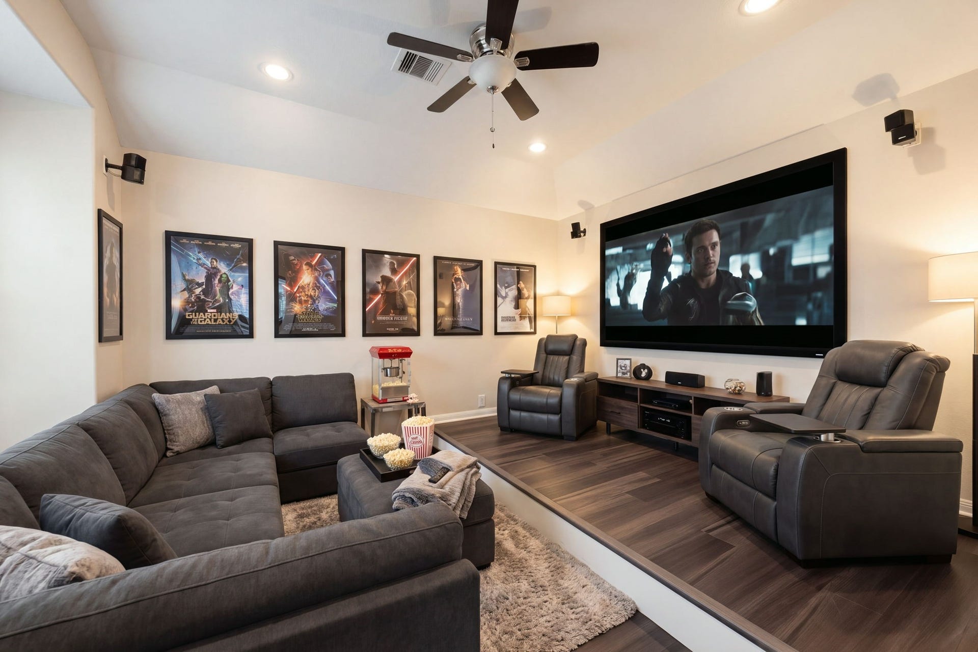 An incredible tiered media room provides the ultimate cinematic experience right at home, complete with custom multi-level riser seating. The thoughtfully designed space features rich dark wood flooring, recessed lighting, a modern ceiling fan, and wall-mounted surround sound speakers for an immersive movie-theater atmosphere. *Virtually Staged