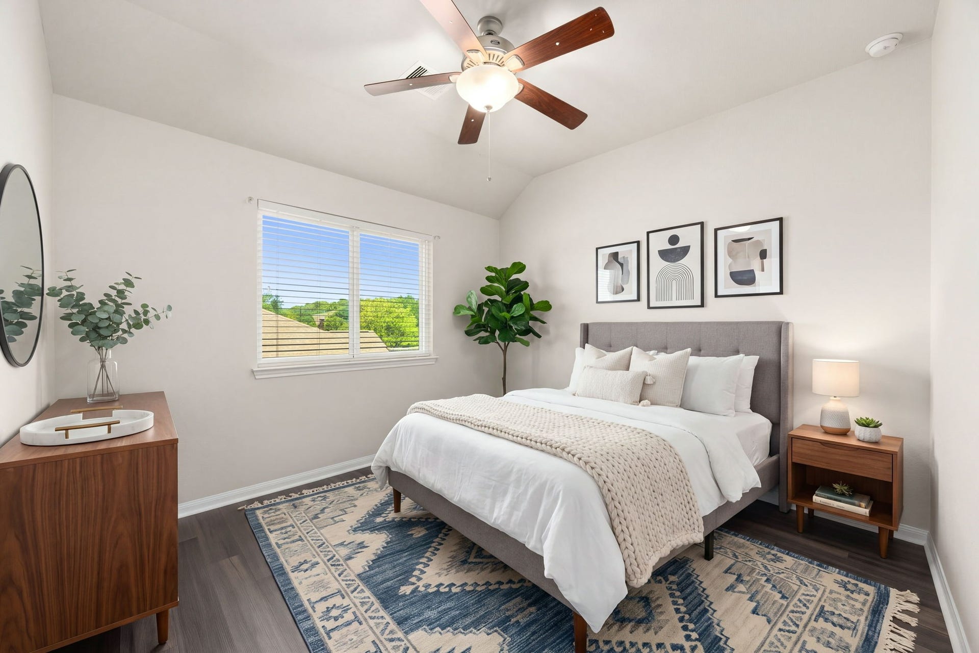 This bright and airy secondary bedroom is one of four spacious additional bedrooms, offering a comfortable retreat for family members or guests. The inviting space boasts a large double window that floods the room with natural light, rich dark wood flooring, a warm wood-blade ceiling fan, and ample closet space. *Virtually Staged