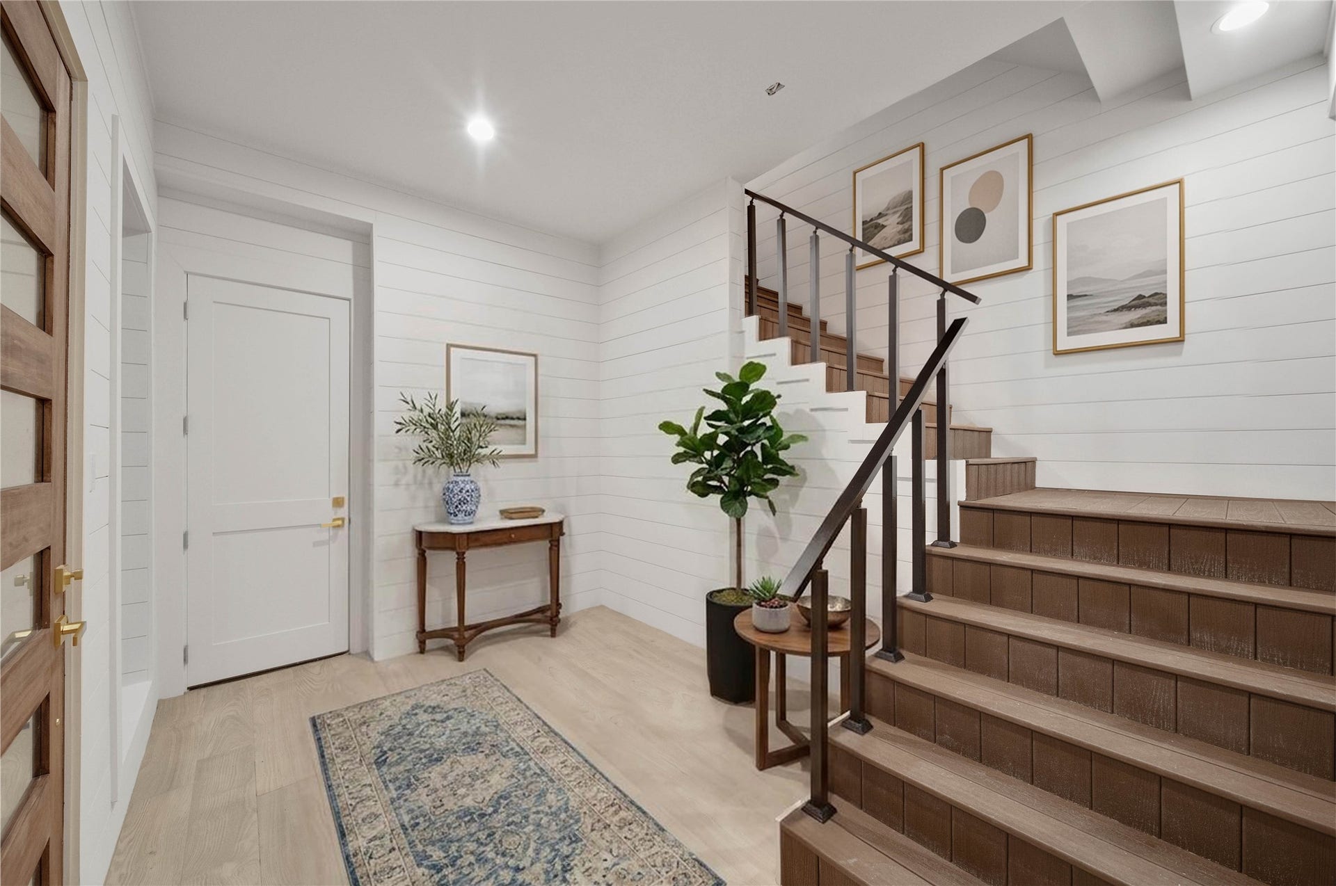 243 Bamaku Bend, Tiki Island, TX 77554 Warm and welcoming entryway with light floors and shiplap walls that enhance the bright, relaxed coastal feel. *virtually staged*