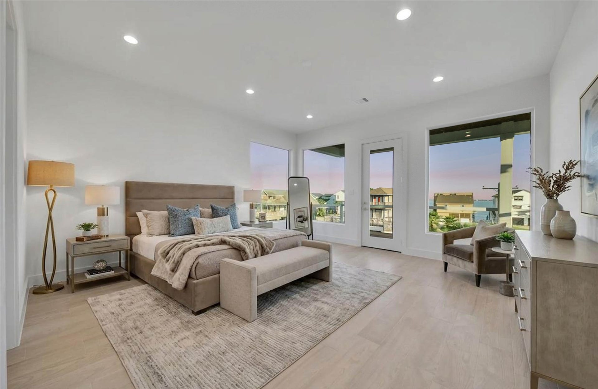 243 Bamaku Bend, Tiki Island, TX 77554 Generously sized primary bedroom with abundant natural light, patio access, and plenty of room for a sitting area.