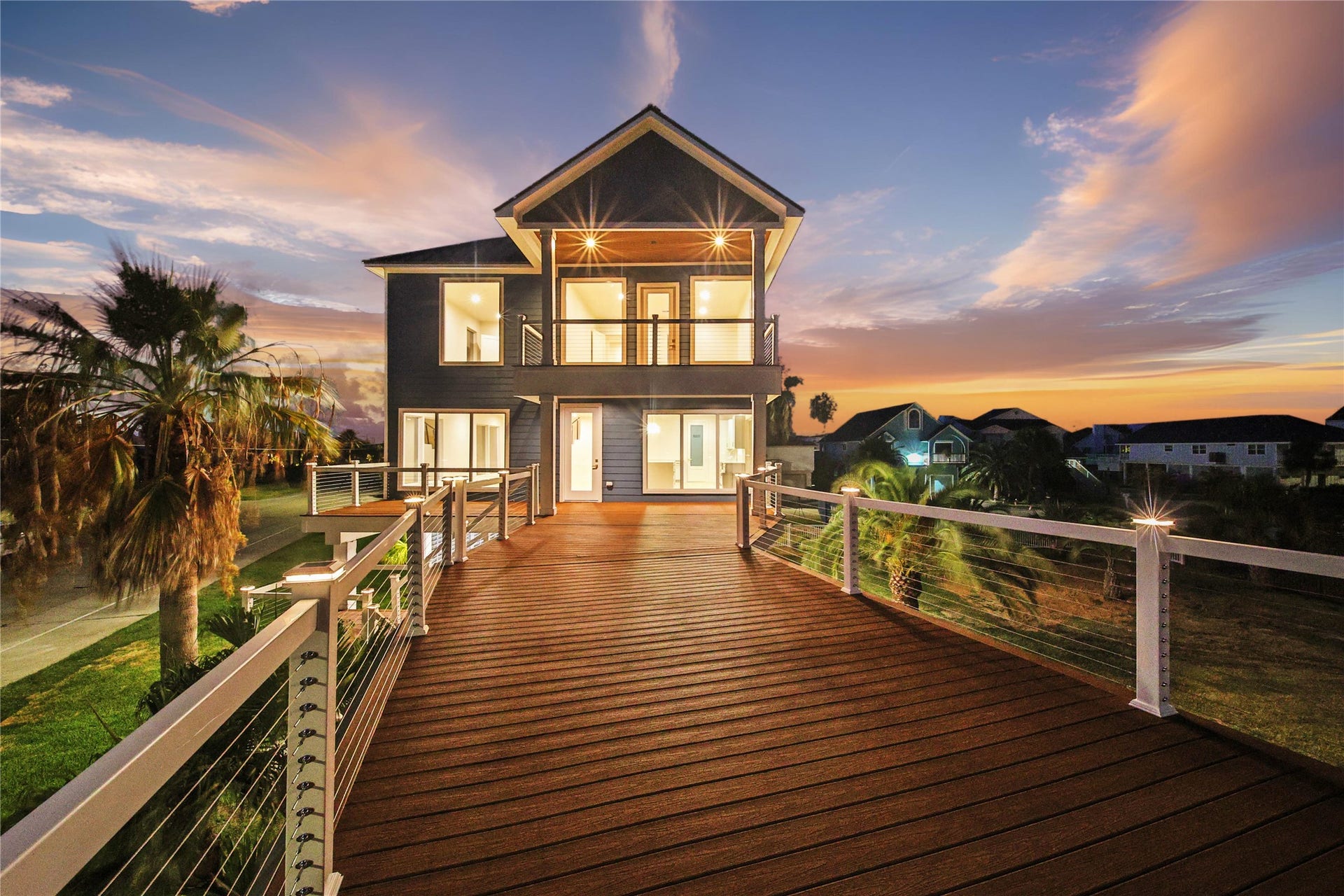 243 Bamaku Bend, Tiki Island, TX 77554 Expansive 12,000+ sqft corner lot on the desired protected canal side with multiple decks and private boat dock.