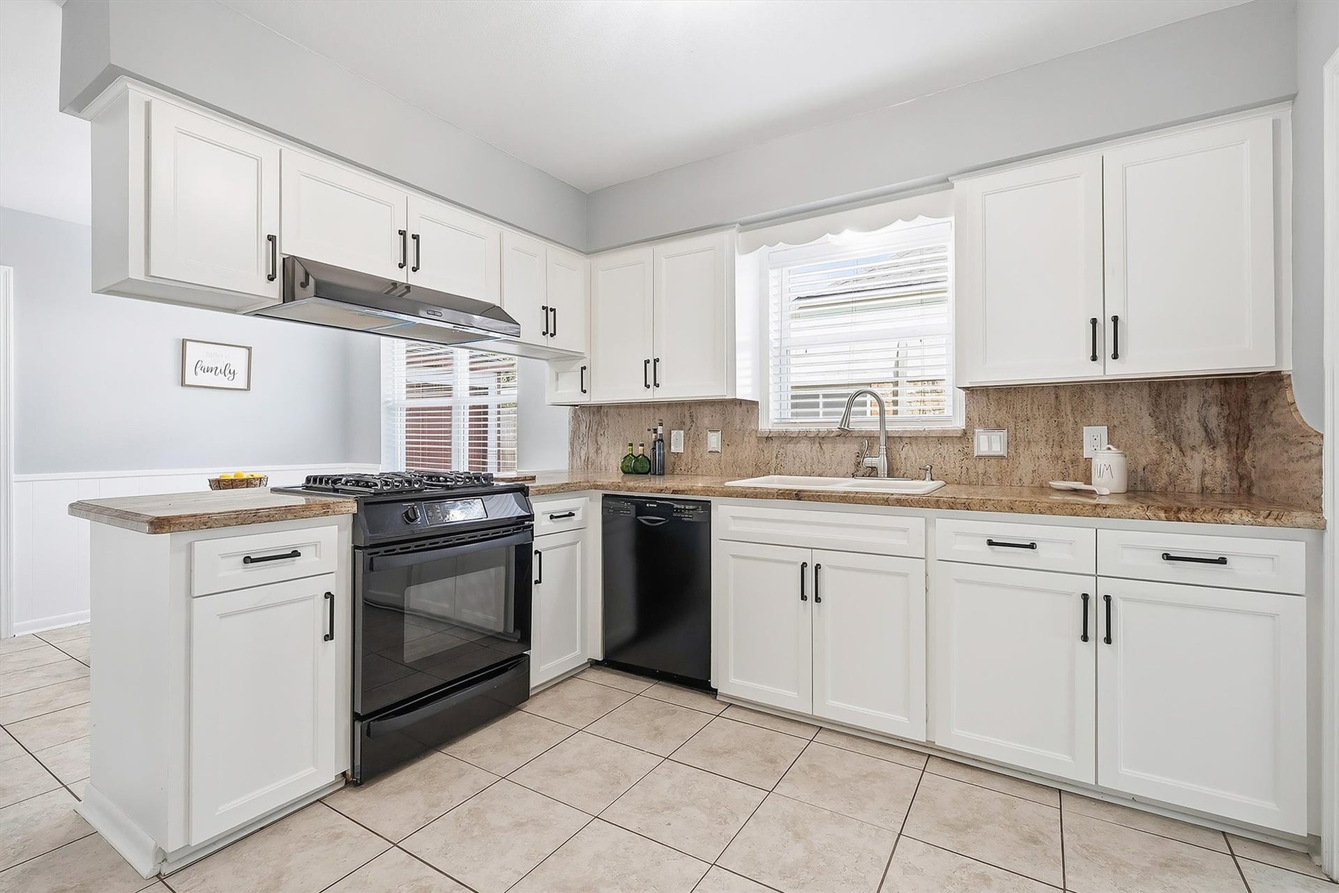 2503 Moss Hill Drive, Houston, TX 77080 Inviting kitchen featuring modern appliances, sleek white cabinetry, and elegant countertops, perfect for culinary enthusiasts.