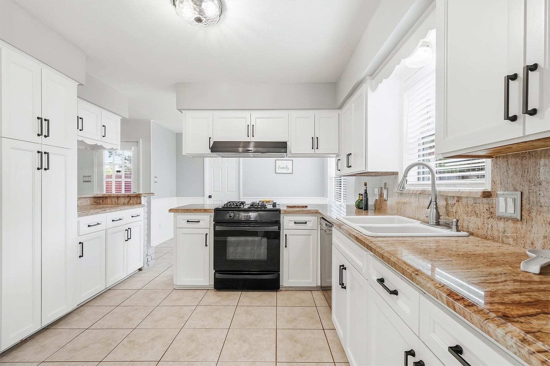 2503 Moss Hill Drive, Houston, TX 77080 Spacious kitchen with elegant white cabinetry, sleek granite countertops, and modern appliances, offering a perfect blend of style and functionality.