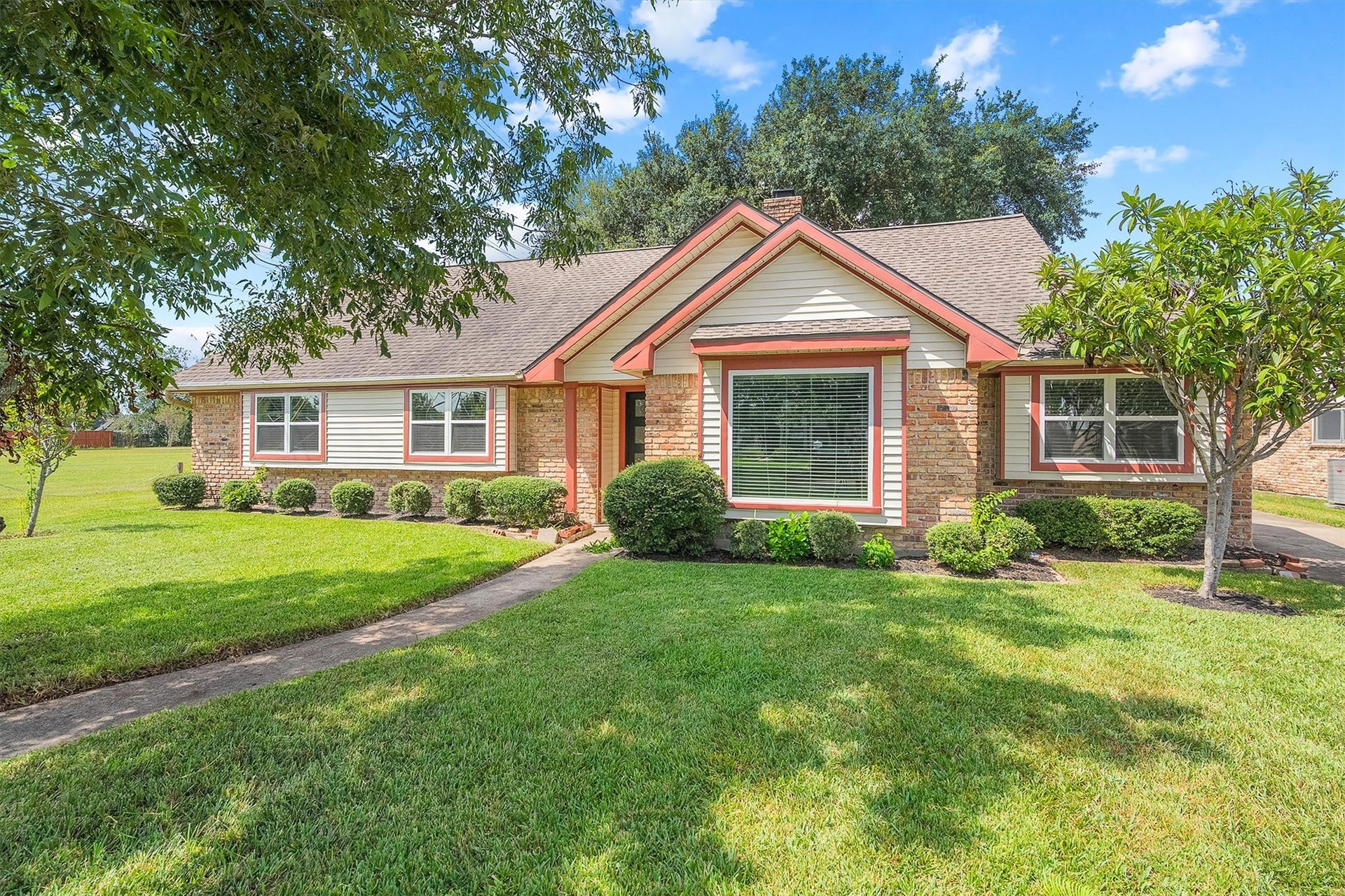 2503 Moss Hill Drive, Houston, TX 77080 Charming brick home with a well-maintained lawn, mature trees, and inviting curb appeal.