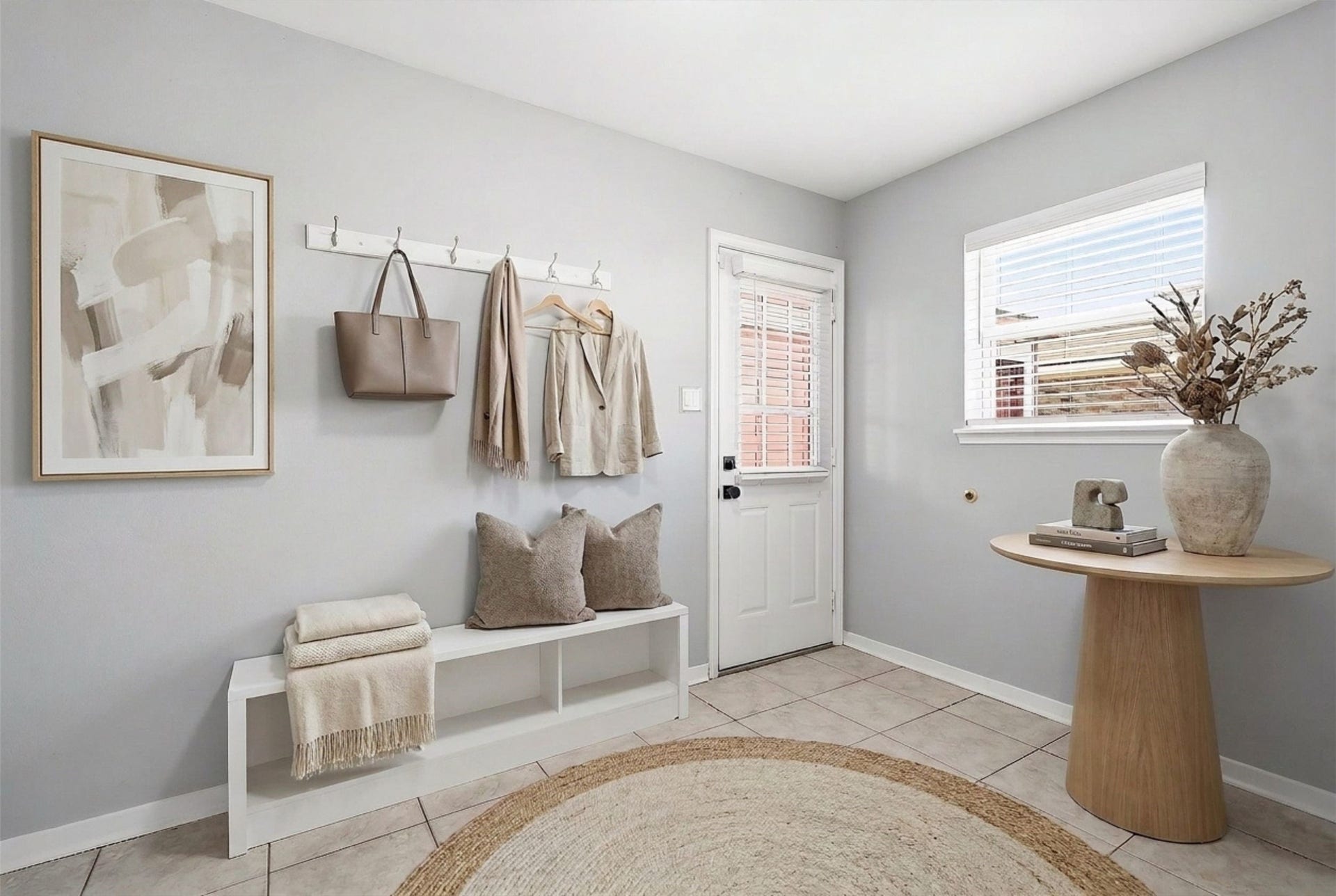 2503 Moss Hill Drive, Houston, TX 77080 Bright and inviting mudroom featuring a cozy seating area with soft, neutral tones. (Virtual staging)