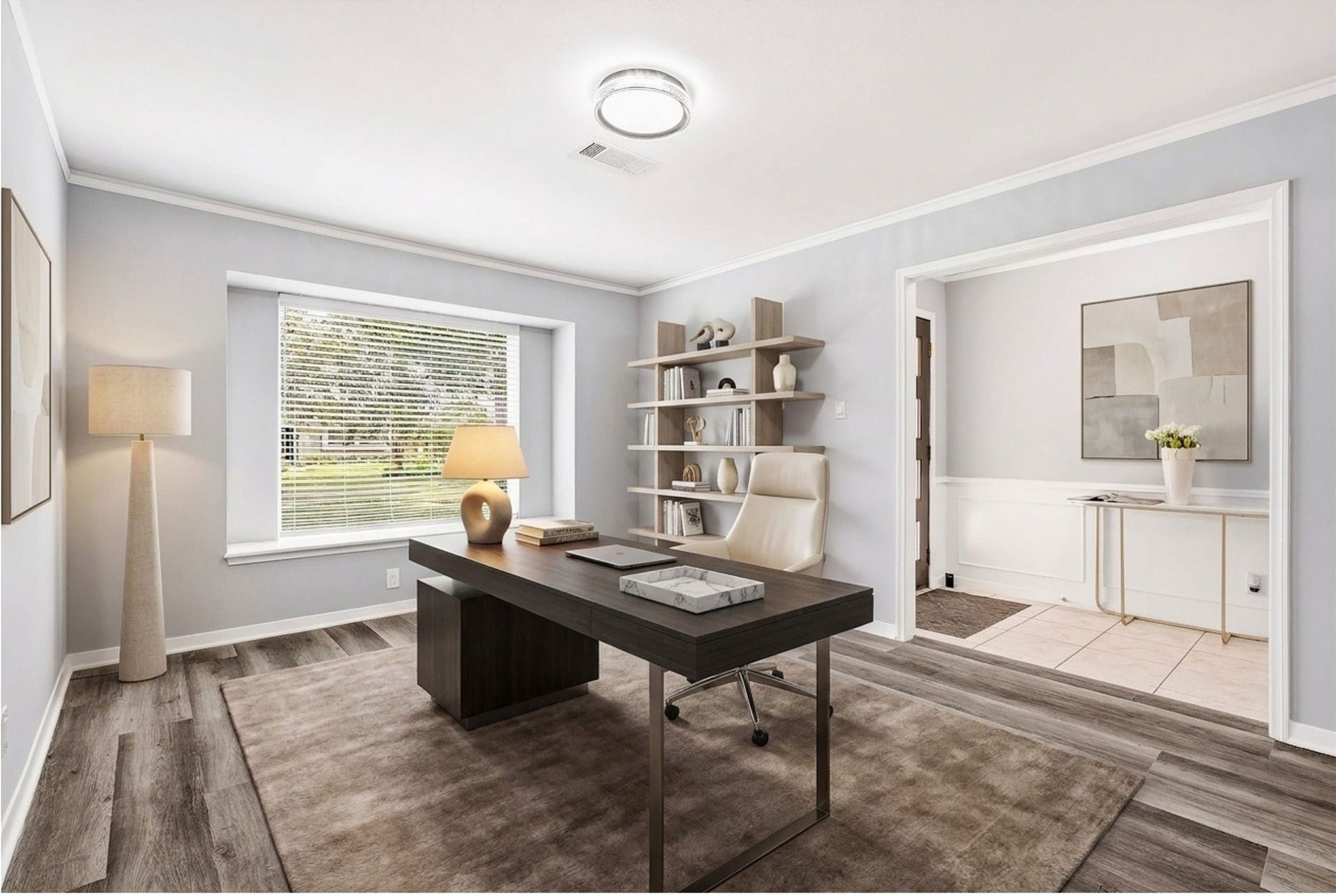 2503 Moss Hill Drive, Houston, TX 77080 Bright and modern home office featuring sleek vinyl plank floors, a large window for natural light, and stylish built-in shelving for ample storage. (Virtual Staging)