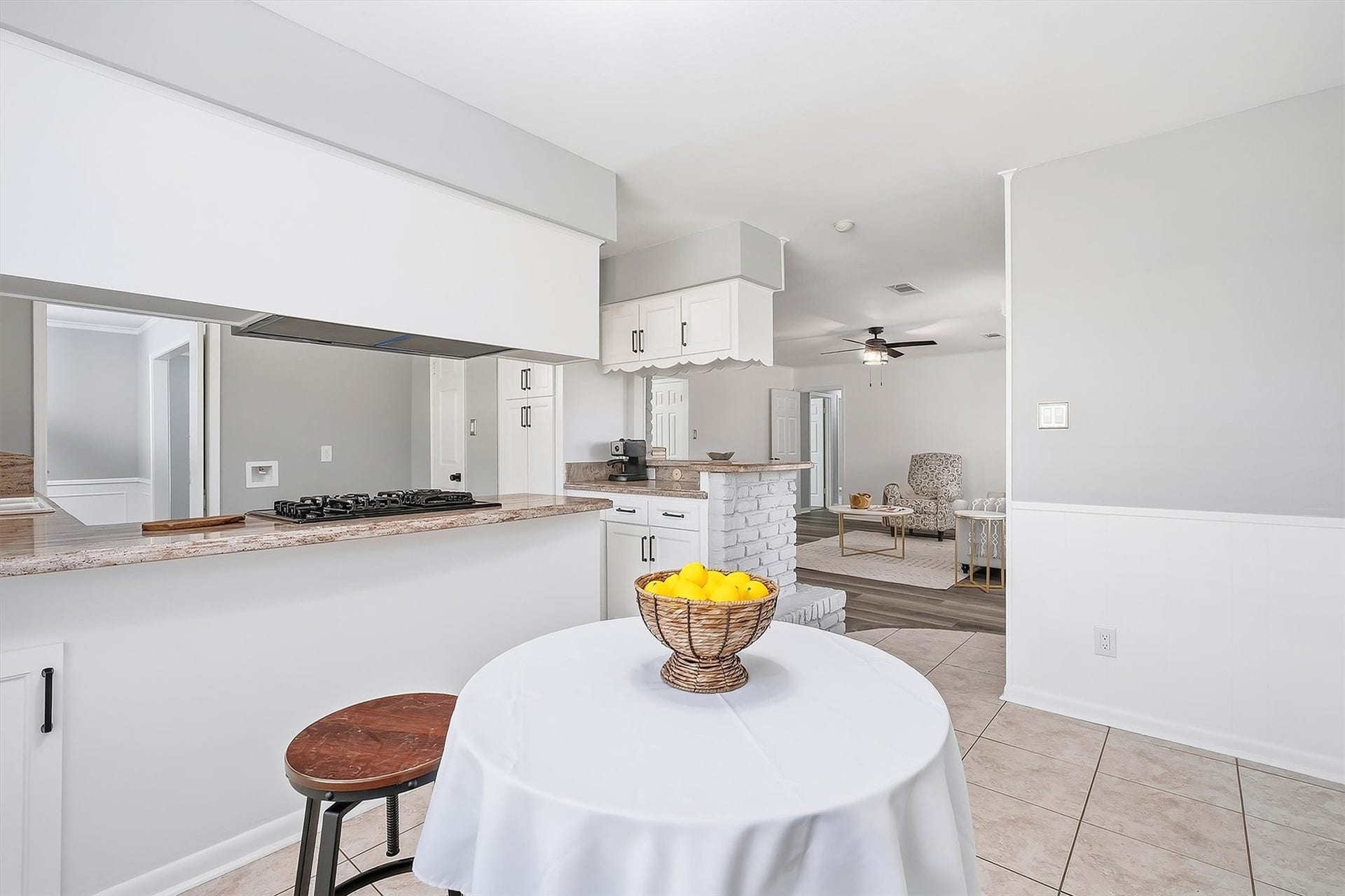 2503 Moss Hill Drive, Houston, TX 77080 Airy open-concept living space featuring a modern kitchen with a breakfast bar, seamless flow to the living area, and neutral tones for a cozy ambiance.