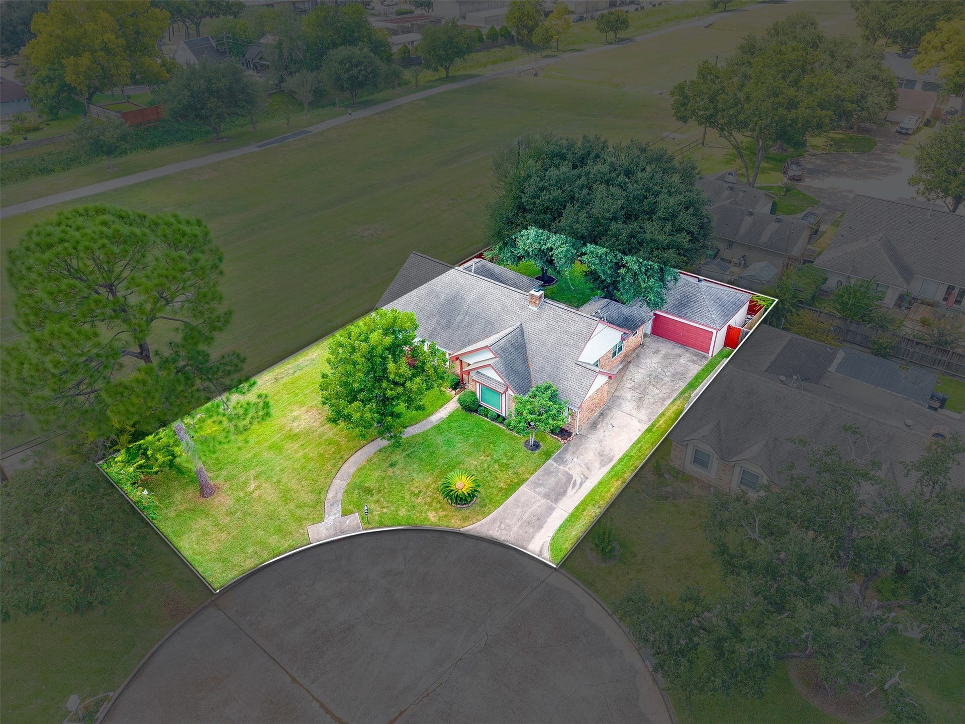 2503 Moss Hill Drive, Houston, TX 77080 Charming home situated on a spacious, lush green lot at the end of a quiet cul-de-sac, featuring a long driveway, mature trees, and a detached garage.