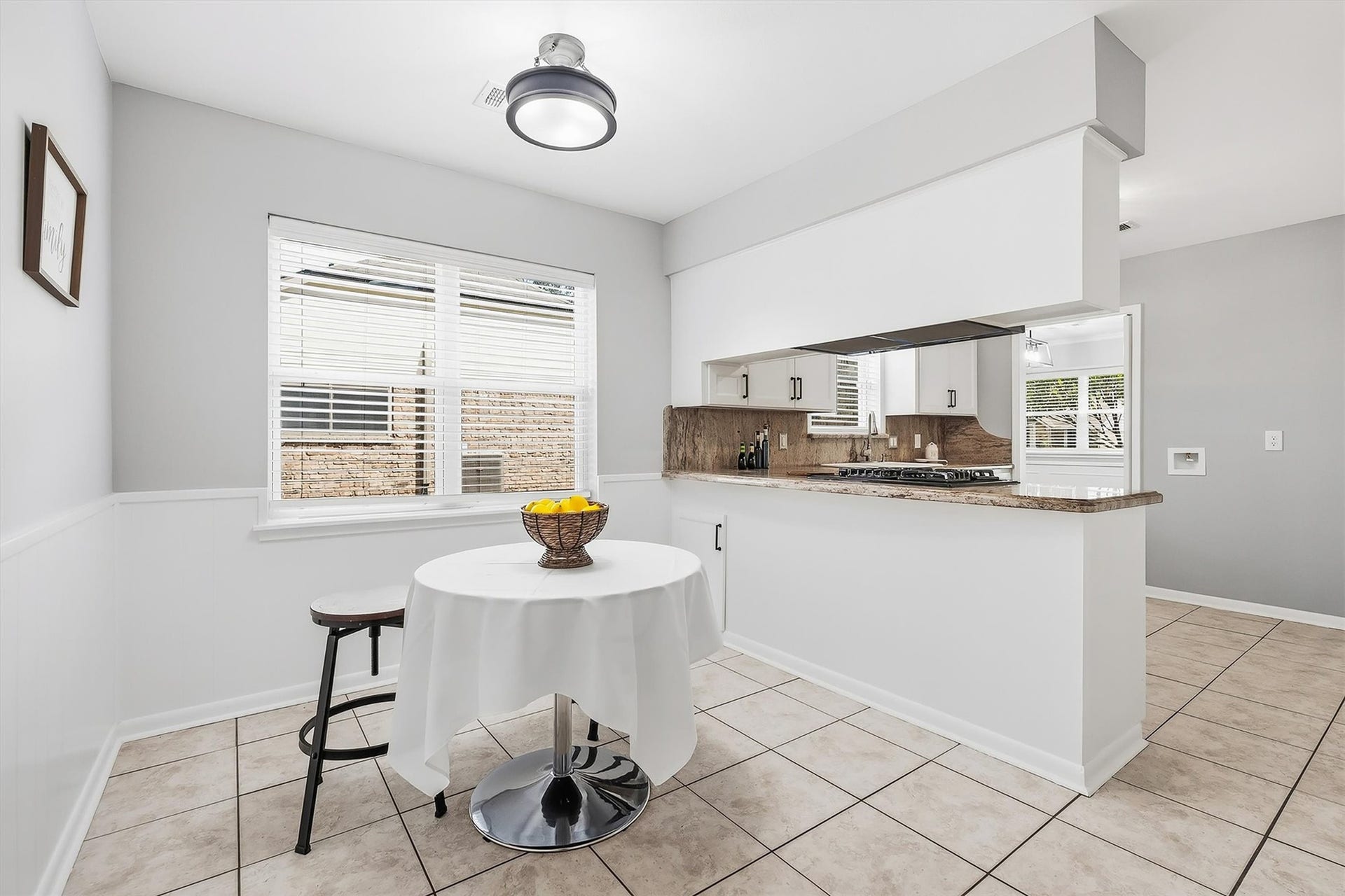 2503 Moss Hill Drive, Houston, TX 77080 Bright breakfast area in the kitchen, modern lighting, and ample natural light, seamlessly connected to a spacious kitchen featuring sleek countertops and a gas cooktop.