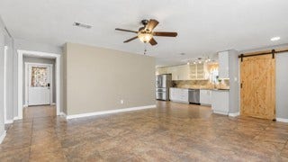 15811 Wandering Trail, Friendswood, TX 77546 View from living into kitchen and the barn door over the utility room brings charm.