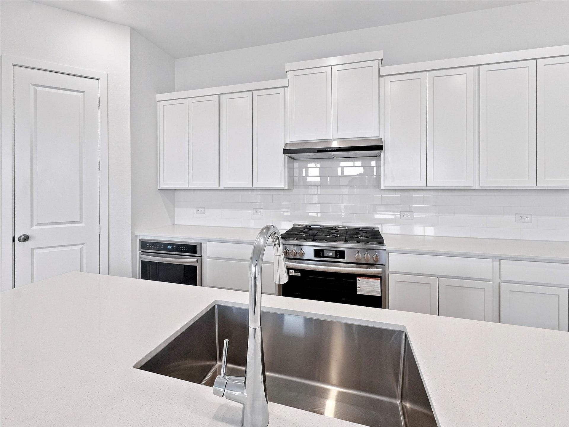 26607 Golden Heather Lane, Katy, TX 77493 Open kitchen with waterfall island and gas range
