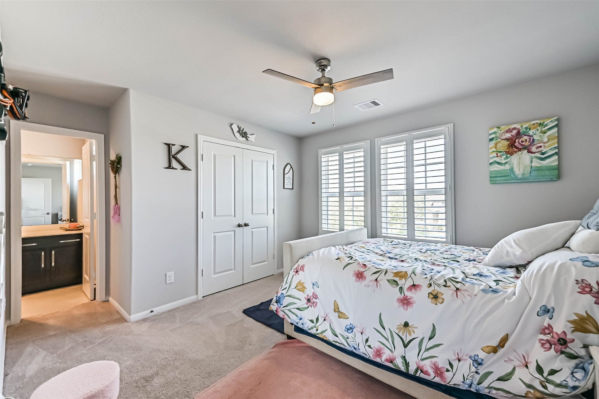 12527 Jetty Cove Drive, Texas City, TX 77568 Comfortable bedroom featuring natural light, plantation shutters, ceiling fan, and convenient bathroom access.