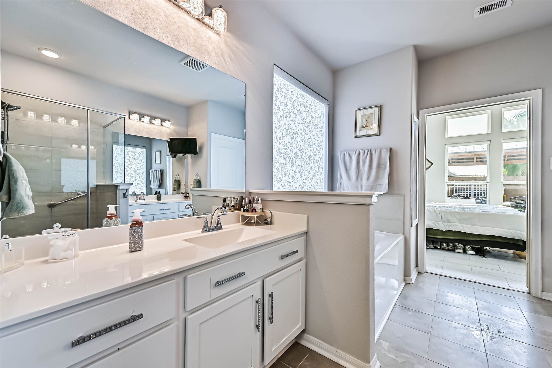 12527 Jetty Cove Drive, Texas City, TX 77568 Additional view of the primary bathroom highlighting the generous counter space, soaking tub, and convenient access to the primary bedroom.