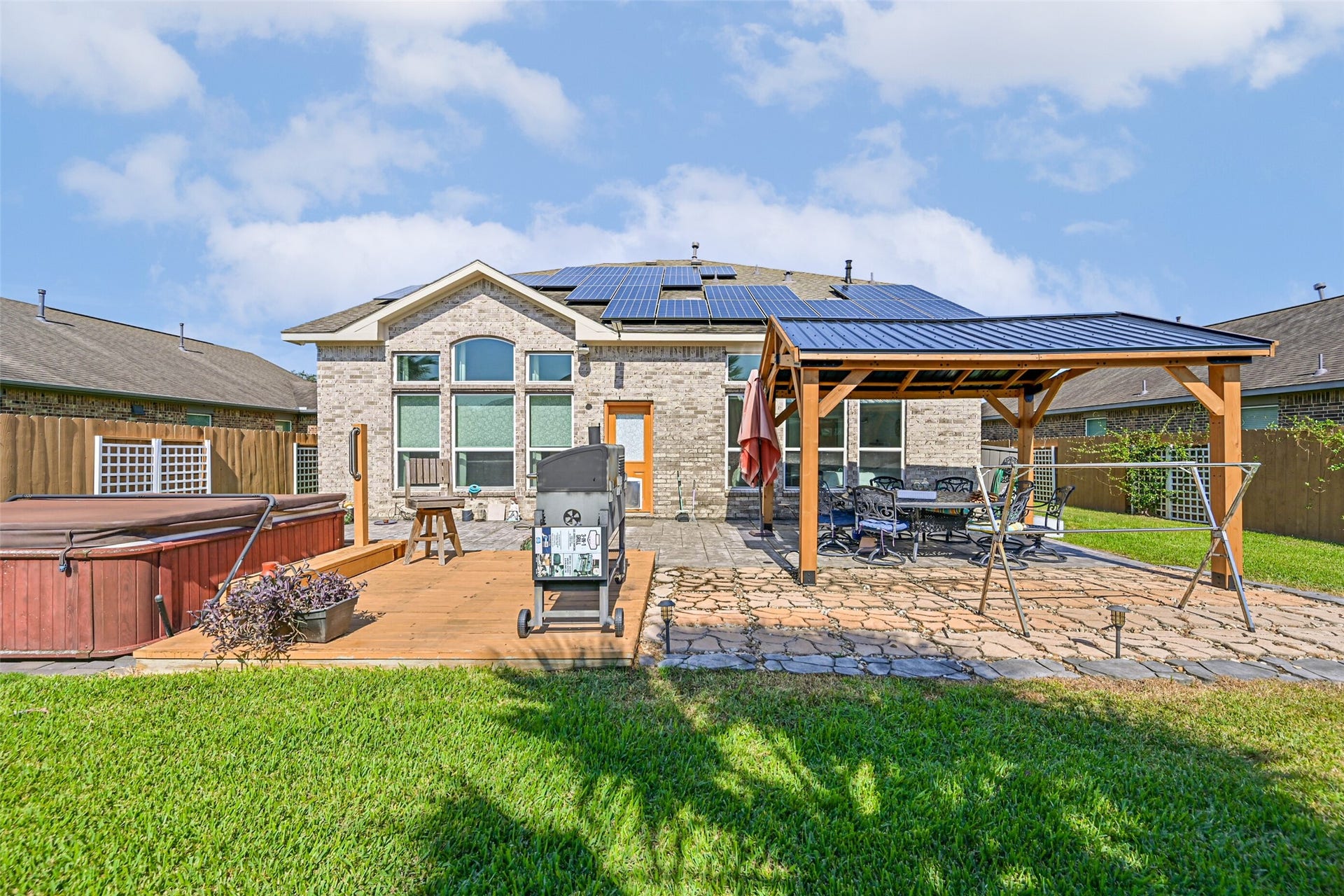 12527 Jetty Cove Drive, Texas City, TX 77568 Enjoy outdoor living with a spacious patio, custom-built covered seating area, and plenty of room for grilling and entertaining.