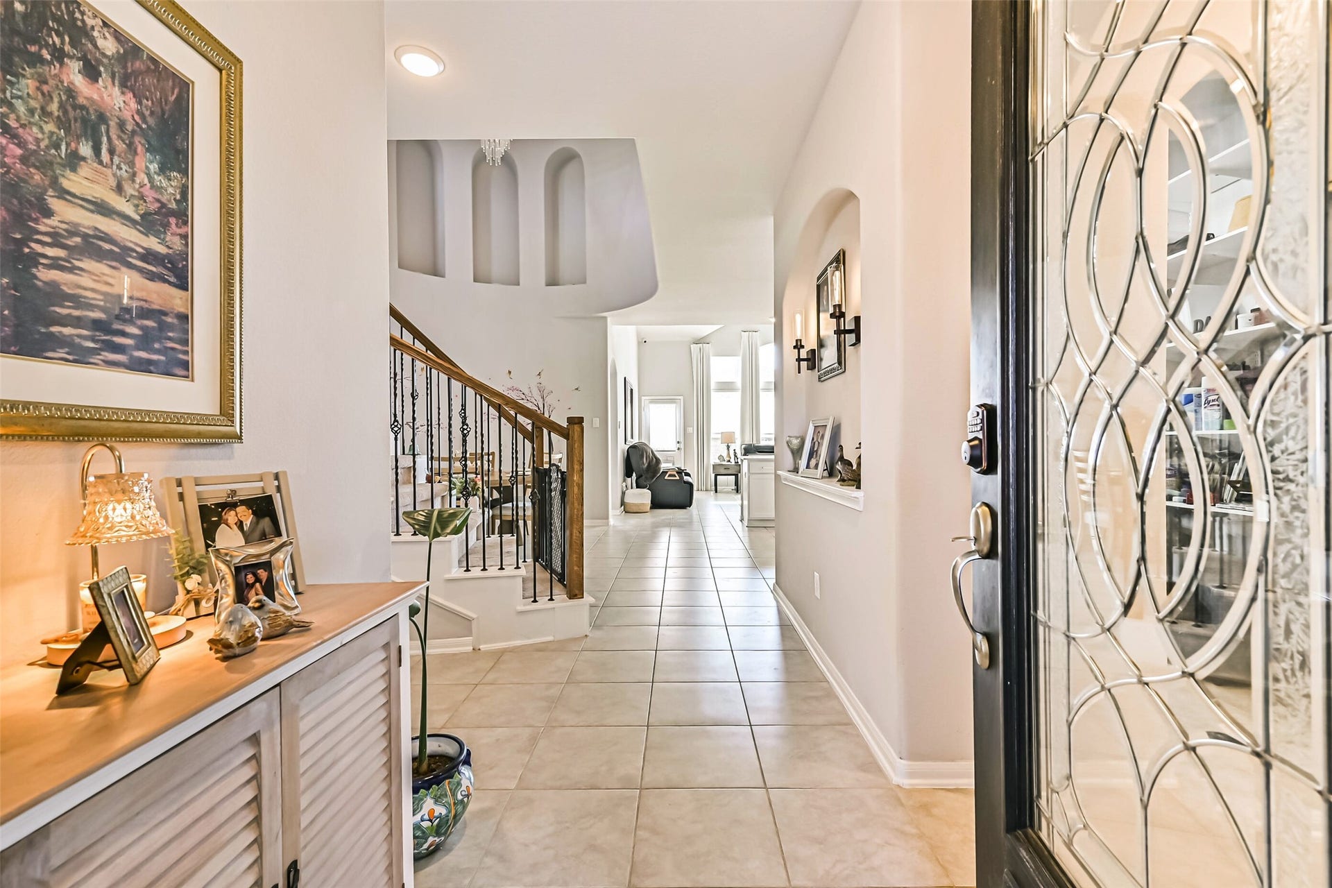 12527 Jetty Cove Drive, Texas City, TX 77568 Welcoming entryway featuring tile flooring, decorative architectural niches, and an elegant staircase leading to the second floor.
