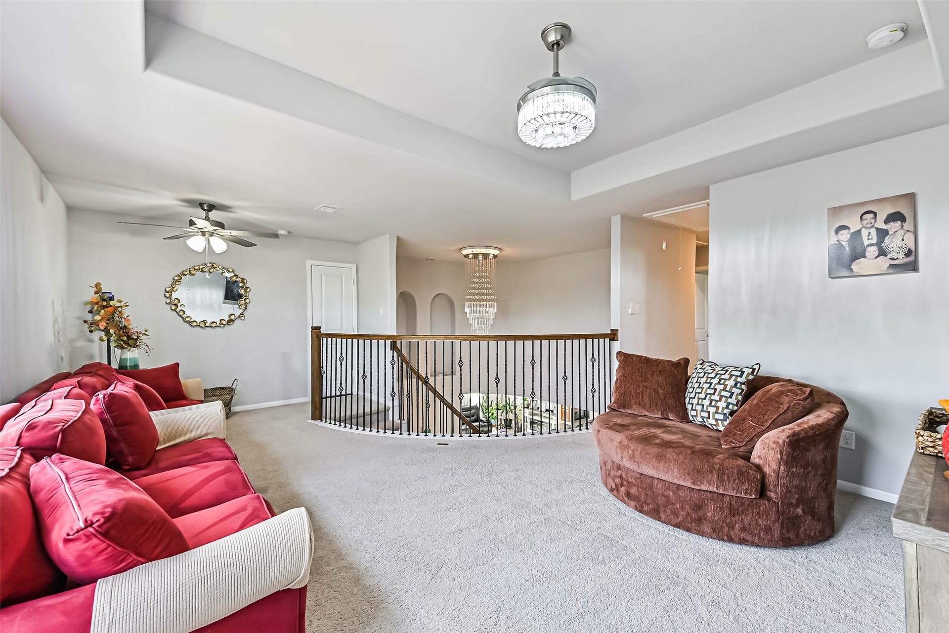 12527 Jetty Cove Drive, Texas City, TX 77568 Spacious upstairs game room featuring tray ceilings, elegant lighting, and an open layout overlooking the first floor.