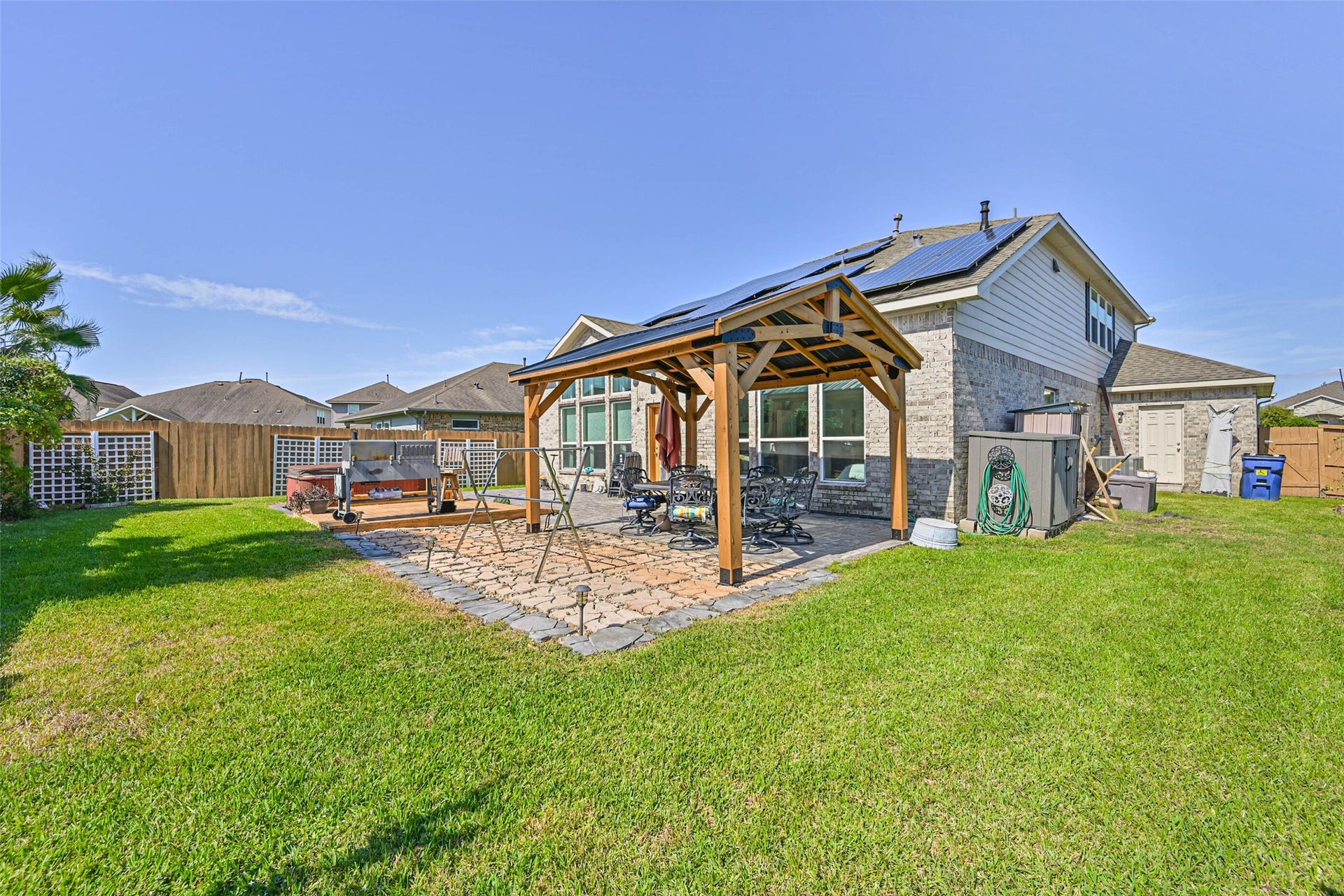 12527 Jetty Cove Drive, Texas City, TX 77568 Inviting backyard oasis with a covered outdoor dining area, lush green lawn, and plenty of space to relax or entertain.