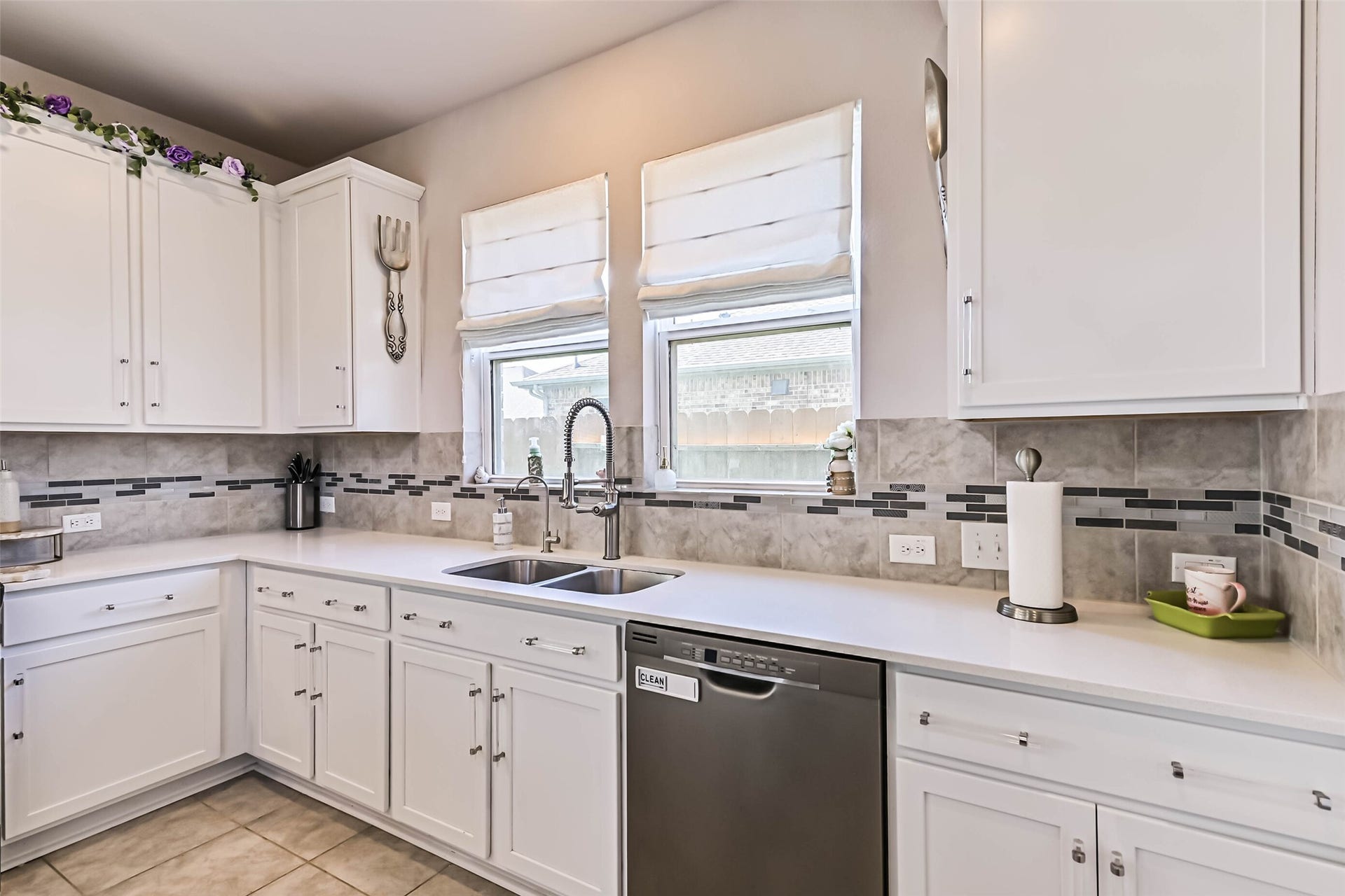 12527 Jetty Cove Drive, Texas City, TX 77568 Kitchen features a double-basin sink, modern pull-down faucet, stainless steel dishwasher, and plenty of counter space.