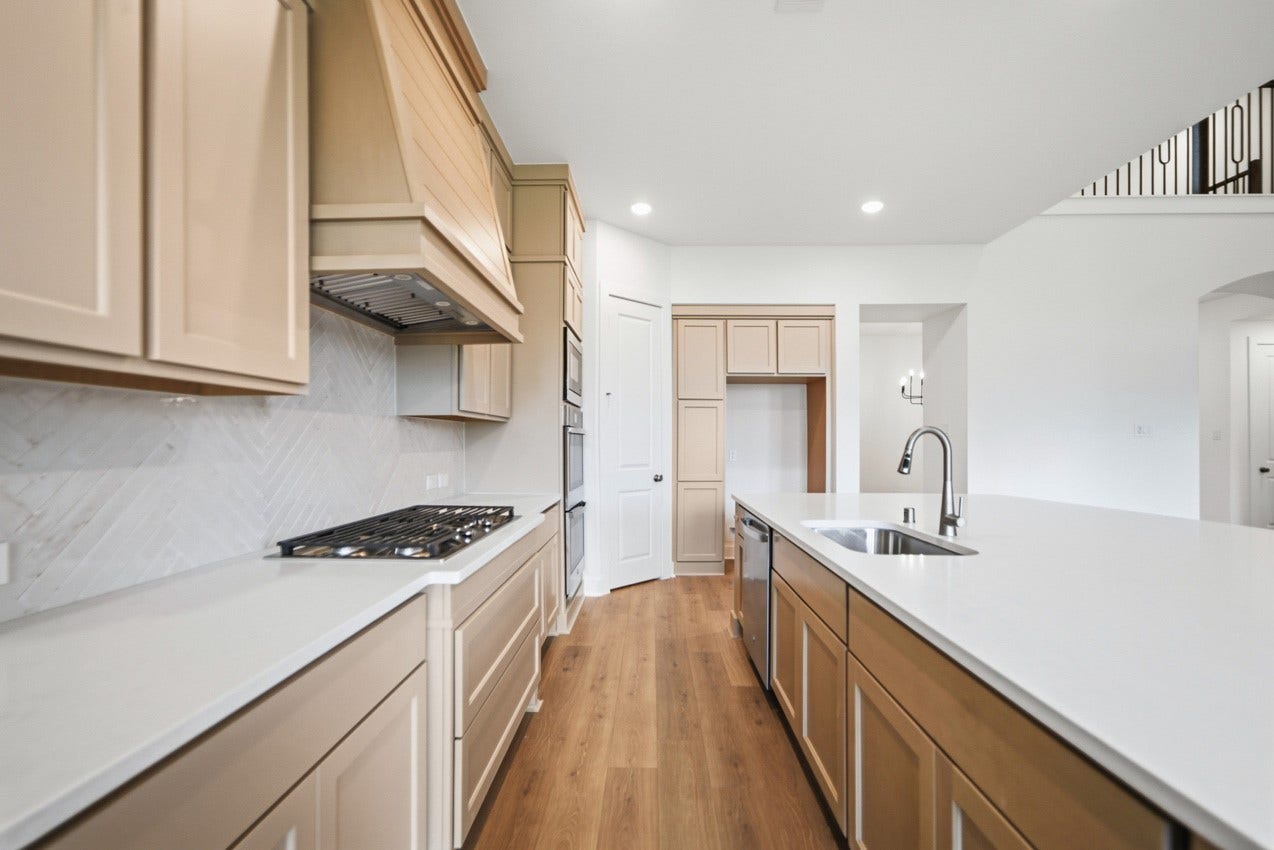1535 Watermont Drive, Missouri City, TX 77459 Chef-inspired kitchen featuring a gas cooktop, built-in appliances, and an efficient workspace.