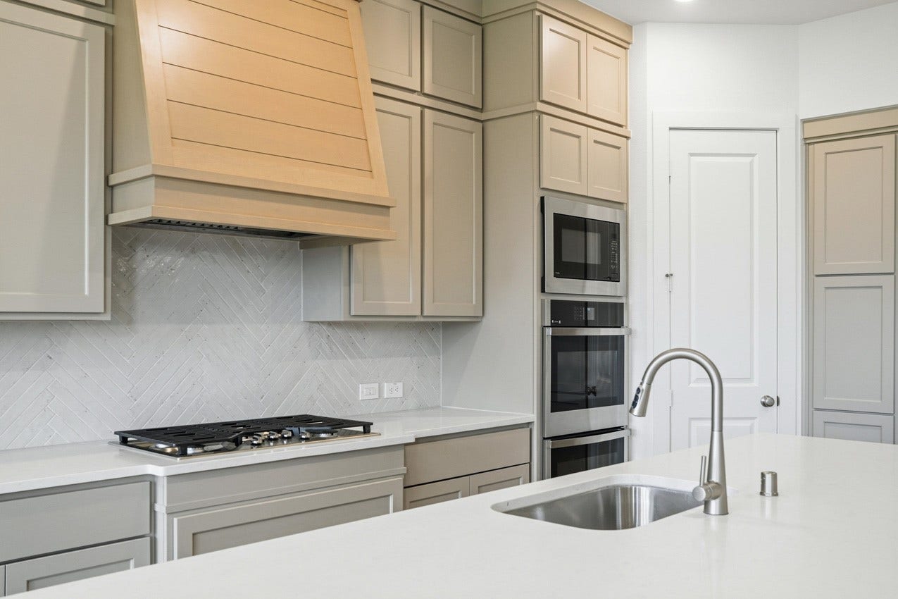 1535 Watermont Drive, Missouri City, TX 77459 Designer kitchen with premium finishes, extensive cabinetry, and modern built-in appliances.