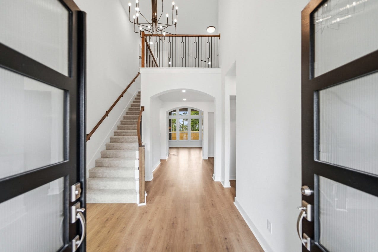 1535 Watermont Drive, Missouri City, TX 77459 Grand foyer featuring soaring ceilings, an elegant staircase, and an impressive first impression.
