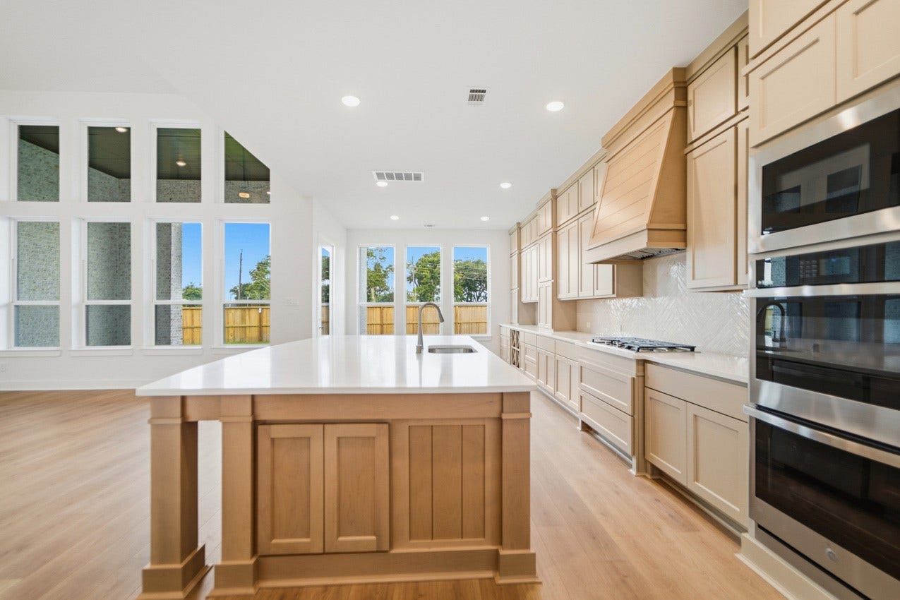 1535 Watermont Drive, Missouri City, TX 77459 Oversized island overlooks the family room and dining area, creating the perfect space for entertaining.