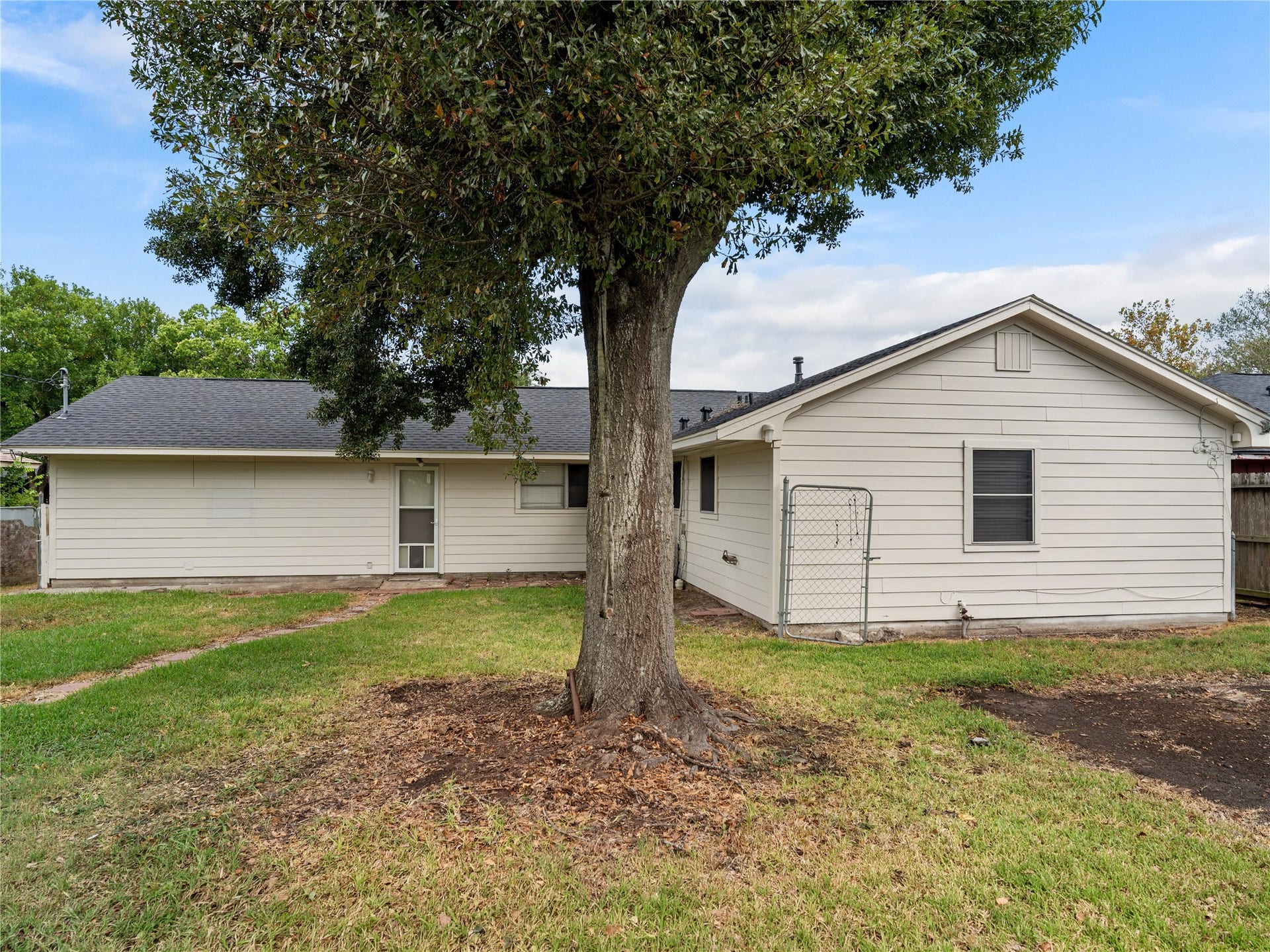 2408 Blueberry Lane, Pasadena, TX 77502 Spacious fenced backyard with mature trees