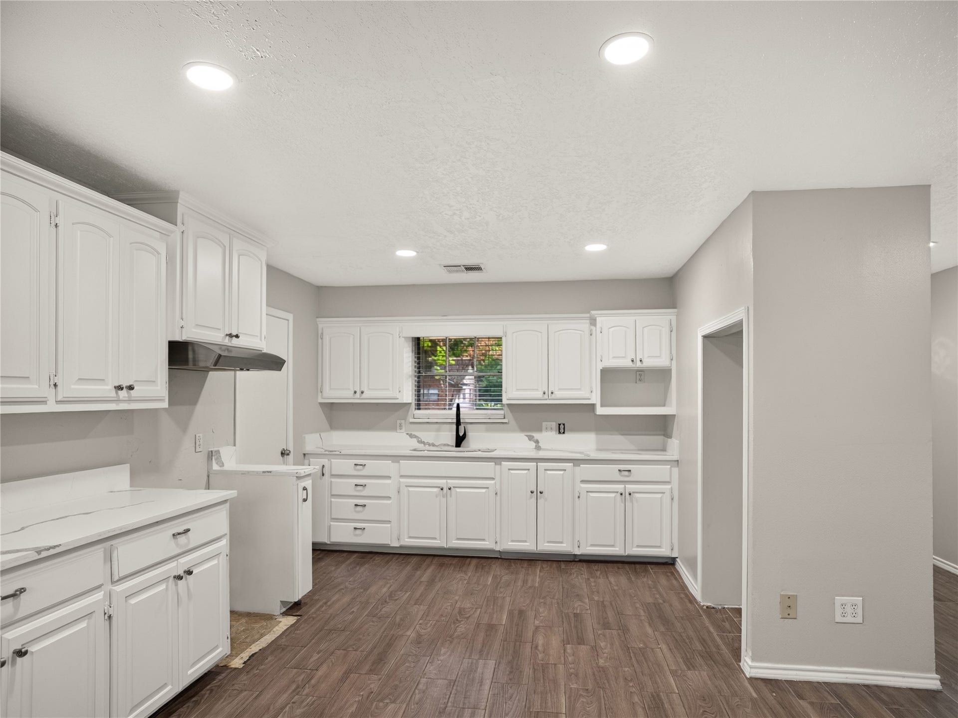 2408 Blueberry Lane, Pasadena, TX 77502 Kitchen featuring white cabinetry and updated QUARTZ countertops