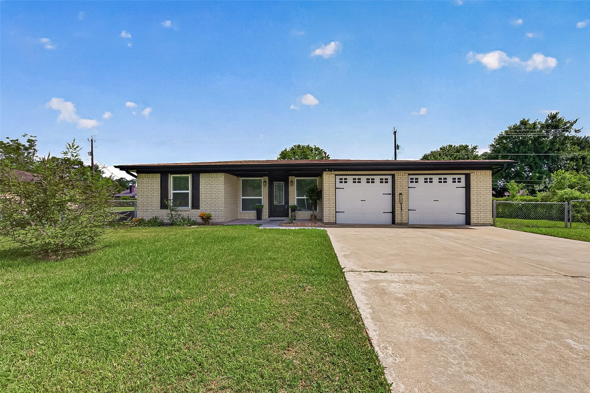 Situated on a spacious .34 acre lot, this inviting property features a generous driveway with plenty of parking and an attached two-car garage.